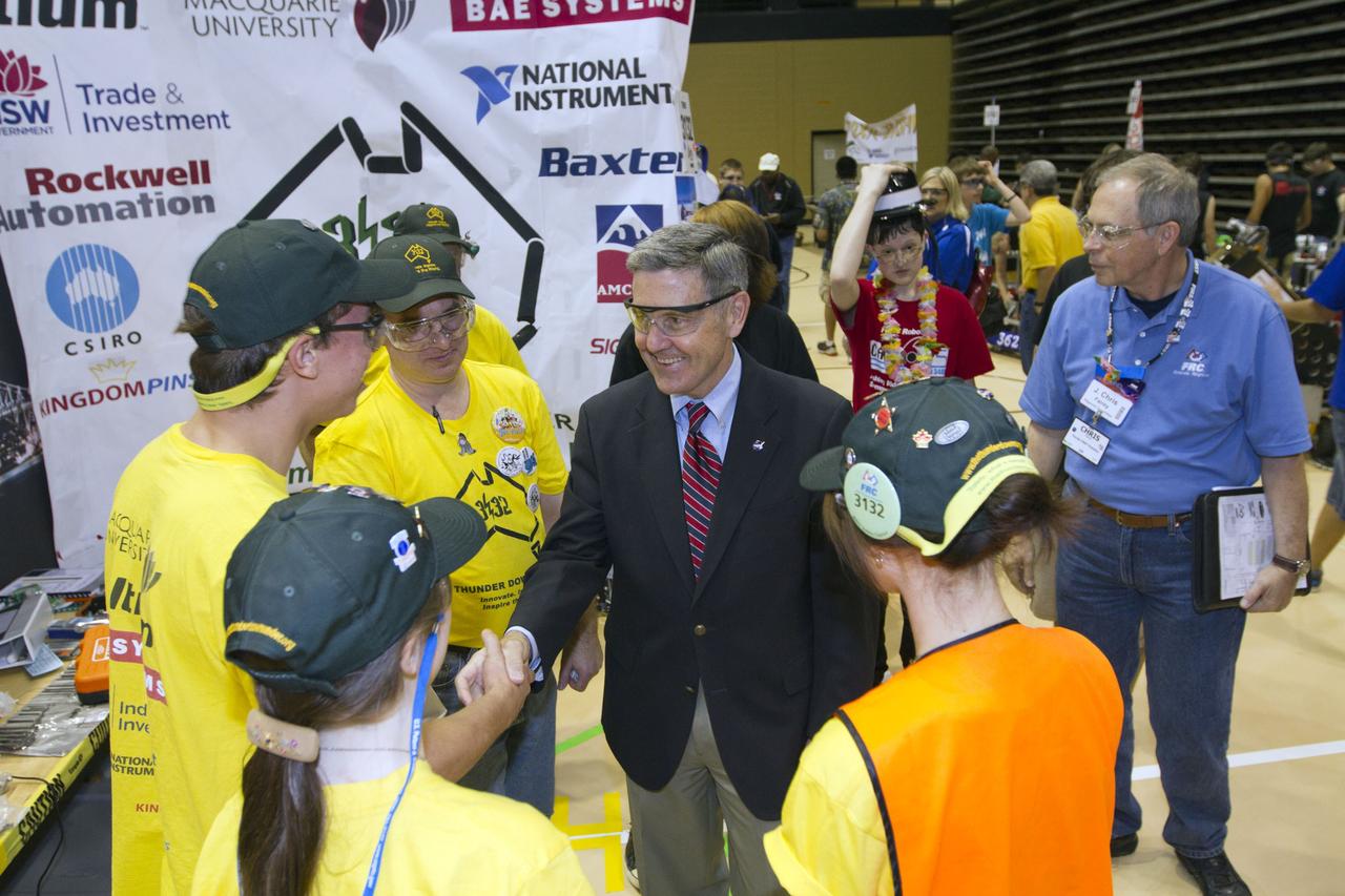 ORLANDO, Fla. -- NASA Kennedy Space Center Director Bob Cabana talks with members of Team 3132, called "Thunder Down Under," which is participating in the regional FIRST robotics competition at the University of Central Florida in Orlando, Fla. The team is made up of students from Sydney, Australia. More than 60 high school teams took part in the competition called "For Inspiration and Recognition of Science and Technology," or FIRST, in hopes of advancing to the national robotics championship. This year, the competition resembled a basketball game and was dubbed "Rebound Rumble." The game measured the effectiveness of each robot, the power of collaboration and the determination of the teams.    FIRST, founded in 1989, is a non-profit organization that designs accessible, innovative programs to build self-confidence, knowledge and life skills while motivating young people to pursue academic opportunities. The robotics competition challenges teams of high school students and their mentors to solve a common problem in a six-week timeframe using a standard kit of parts and a common set of rules. NASA is the largest sponsor of the international program. Kennedy Space Center is a sponsor of the regional event. For more information on Kennedy's education events and initiatives, go to http://www.nasa.gov/offices/education/centers/kennedy/home/index.html. Photo credit: NASA/Kim Shiflett