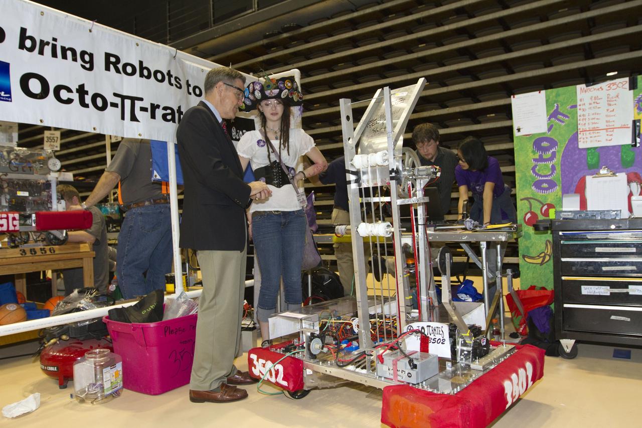 ORLANDO, Fla. -- NASA Kennedy Space Center Director Bob Cabana talks with a member of Team 3502, called "The Octo Pie-Rates," which is participating in the regional FIRST robotics competition at the University of Central Florida in Orlando, Fla. The team is made up of students from the School for Arts and Innovative Learning SAIL High School in Tallahassee. More than 60 high school teams took part in the competition called "For Inspiration and Recognition of Science and Technology," or FIRST, in hopes of advancing to the national robotics championship. This year, the competition resembled a basketball game and was dubbed "Rebound Rumble." The game measured the effectiveness of each robot, the power of collaboration and the determination of the teams.    FIRST, founded in 1989, is a non-profit organization that designs accessible, innovative programs to build self-confidence, knowledge and life skills while motivating young people to pursue academic opportunities. The robotics competition challenges teams of high school students and their mentors to solve a common problem in a six-week timeframe using a standard kit of parts and a common set of rules. NASA is the largest sponsor of the international program. Kennedy Space Center is a sponsor of the regional event. For more information on Kennedy's education events and initiatives, go to http://www.nasa.gov/offices/education/centers/kennedy/home/index.html. Photo credit: NASA/Kim Shiflett