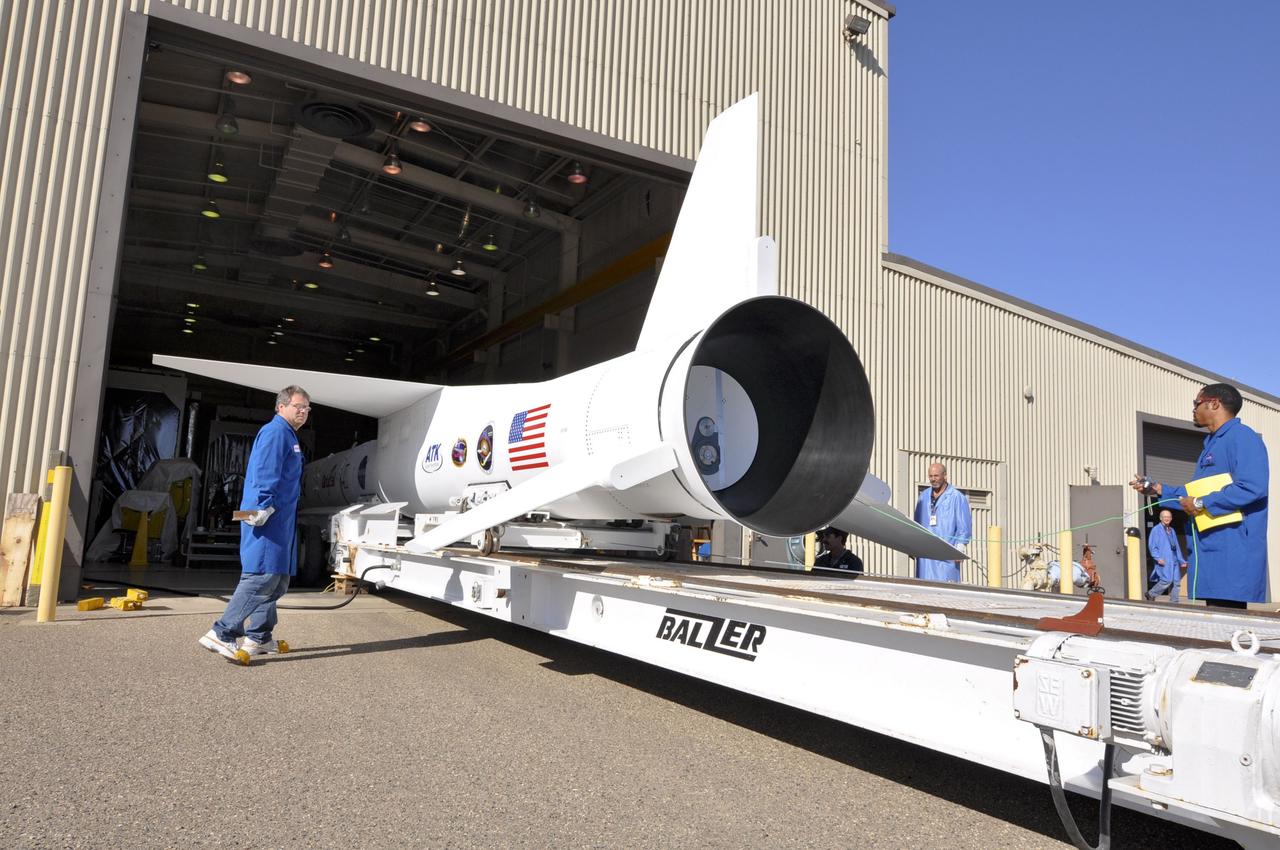 VANDENBERG AIR FORCE BASE, Calif. – Orbital Sciences’ technicians monitor the transporter supporting Orbital’s Pegasus XL rocket as it moves through the open door of Orbital’s hangar at Vandenberg Air Force Base in California. The rocket is mated to NASA's Nuclear Spectroscopic Telescope Array, or NuSTAR, encapsulated in the Pegasus payload fairing. The transporter will move them to the runway ramp where they will be attached to the underside of Orbital’s L-1011 carrier aircraft. The aircraft will fly the pair from Vandenberg to the Ronald Reagan Ballistic Missile Defense Test Site on the Pacific Ocean’s Kwajalein Atoll for launch. A revised launch date will be set at the Flight Readiness Review, planned for later this week. The high-energy X-ray telescope will conduct a census of black holes, map radioactive material in young supernovae remnants, and study the origins of cosmic rays and the extreme physics around collapsed stars. For more information, visit http://www.nasa.gov/nustar. Photo credit: NASA/Randy Beaudoin, VAFB