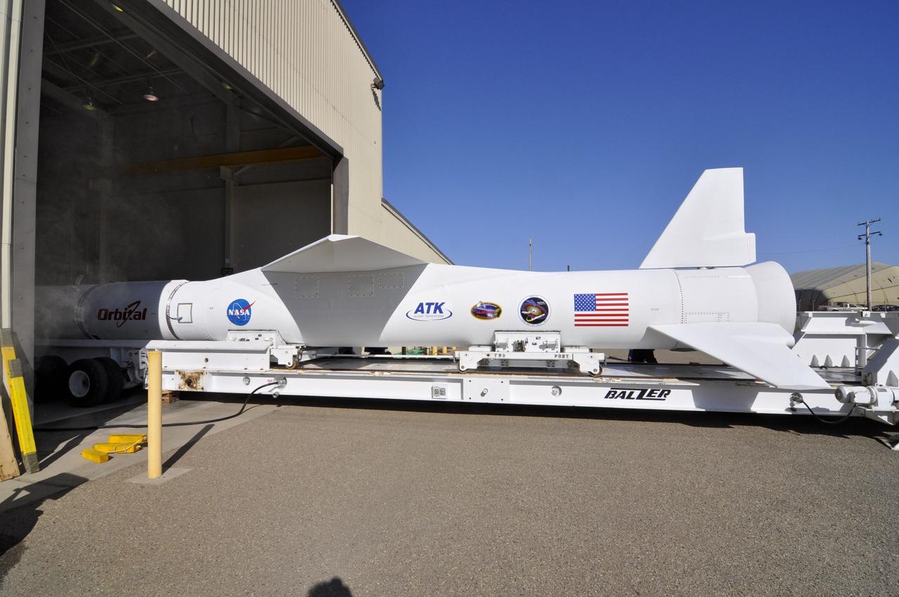 VANDENBERG AIR FORCE BASE, Calif. – An Orbital Sciences’ Pegasus XL rocket rests atop the transporter outside Orbital’s hangar at Vandenberg Air Force Base in California. The rocket is mated to NASA's encapsulated Nuclear Spectroscopic Telescope Array, or NuSTAR, out of sight inside the hangar. The transporter will move them to the runway ramp where they will be attached to the underside of Orbital’s L-1011 carrier aircraft. The aircraft will fly the pair from Vandenberg to the Ronald Reagan Ballistic Missile Defense Test Site on the Pacific Ocean’s Kwajalein Atoll for launch. A revised launch date will be set at the Flight Readiness Review, planned for later this week. The high-energy X-ray telescope will conduct a census of black holes, map radioactive material in young supernovae remnants, and study the origins of cosmic rays and the extreme physics around collapsed stars. For more information, visit http://www.nasa.gov/nustar. Photo credit: NASA/Randy Beaudoin, VAFB