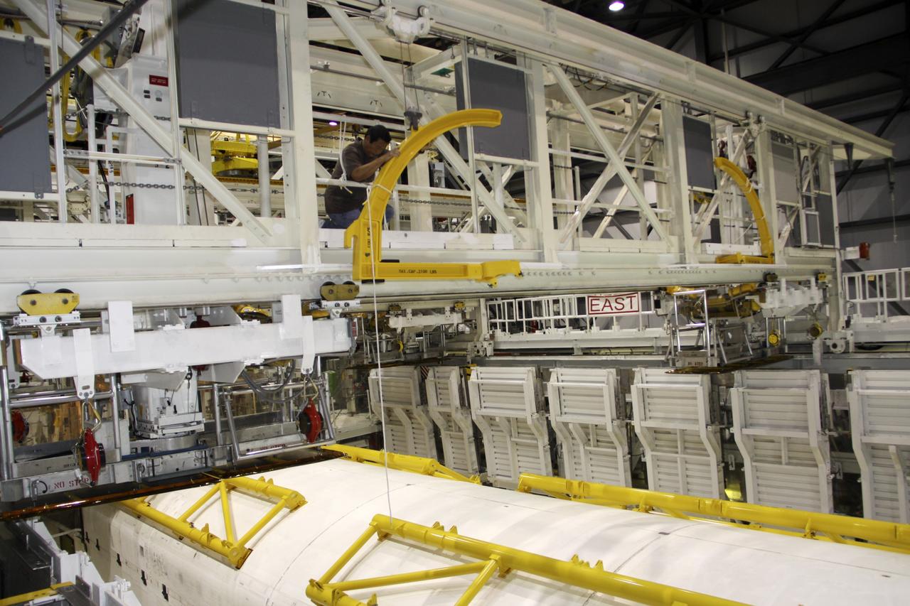 CAPE CANAVERAL, Fla. – In Orbiter Processing Facility-1 at NASA’s Kennedy Space Center in Florida, a United Space Alliance technician prepares to open the payload bay doors of space shuttle Atlantis with the assistance of the yellow strongbacks attached to the doors. Strongbacks are used to support and operate the doors when the shuttle is not in space. The work is part of the Space Shuttle Program’s transition and retirement processing of shuttle Atlantis. A groundbreaking was held Jan. 18 for Atlantis' future home -- a 65,000-square-foot exhibit hall in Shuttle Plaza at the Kennedy Space Center Visitor Complex. For more information, visit http://www.nasa.gov/shuttle. Photo credit: NASA/Jim Grossmann