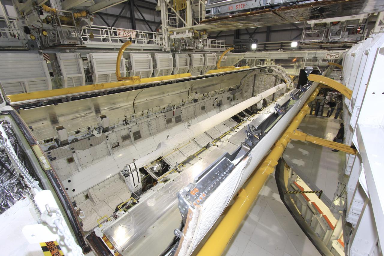 CAPE CANAVERAL, Fla. – In Orbiter Processing Facility-1 at NASA’s Kennedy Space Center in Florida, the payload bay of space shuttle Atlantis comes into view as one of the bay doors swings open with the help of the strongbacks attached. Strongbacks are used to support and operate the doors when the shuttle is not in space. The work is part of the Space Shuttle Program’s transition and retirement processing of shuttle Atlantis. A groundbreaking was held Jan. 18 for Atlantis' future home -- a 65,000-square-foot exhibit hall in Shuttle Plaza at the Kennedy Space Center Visitor Complex. For more information, visit http://www.nasa.gov/shuttle. Photo credit: NASA/Jim Grossmann