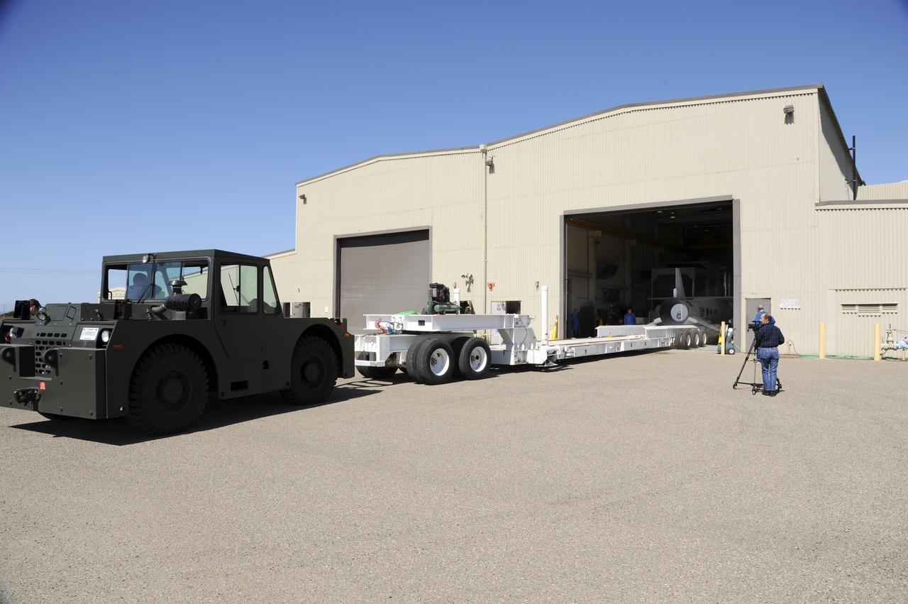 VANDENBERG AIR FORCE BASE, Calif. – At Vandenberg Air Force Base in California, a transporter is moved toward the Orbital Science’s Pegasus XL inside Orbital’s hangar. The rocket is mated to NASA’s encapsulated Nuclear Spectroscopic Telescope Array, or NuSTAR, out of sight inside the hangar. The transporter will move them to the runway ramp where they will be attached to the underside of Orbital’s L-1011 carrier aircraft. The aircraft will fly the pair from Vandenberg to the Ronald Reagan Ballistic Missile Defense Test Site on the Pacific Ocean’s Kwajalein Atoll for launch. A revised launch date is expected to be set at the Flight Readiness Review. The high-energy X-ray telescope will conduct a census of black holes, map radioactive material in young supernovae remnants, and study the origins of cosmic rays and the extreme physics around collapsed stars. For more information, visit http://www.nasa.gov/nustar. Photo credit: NASA/Mark Mackiey