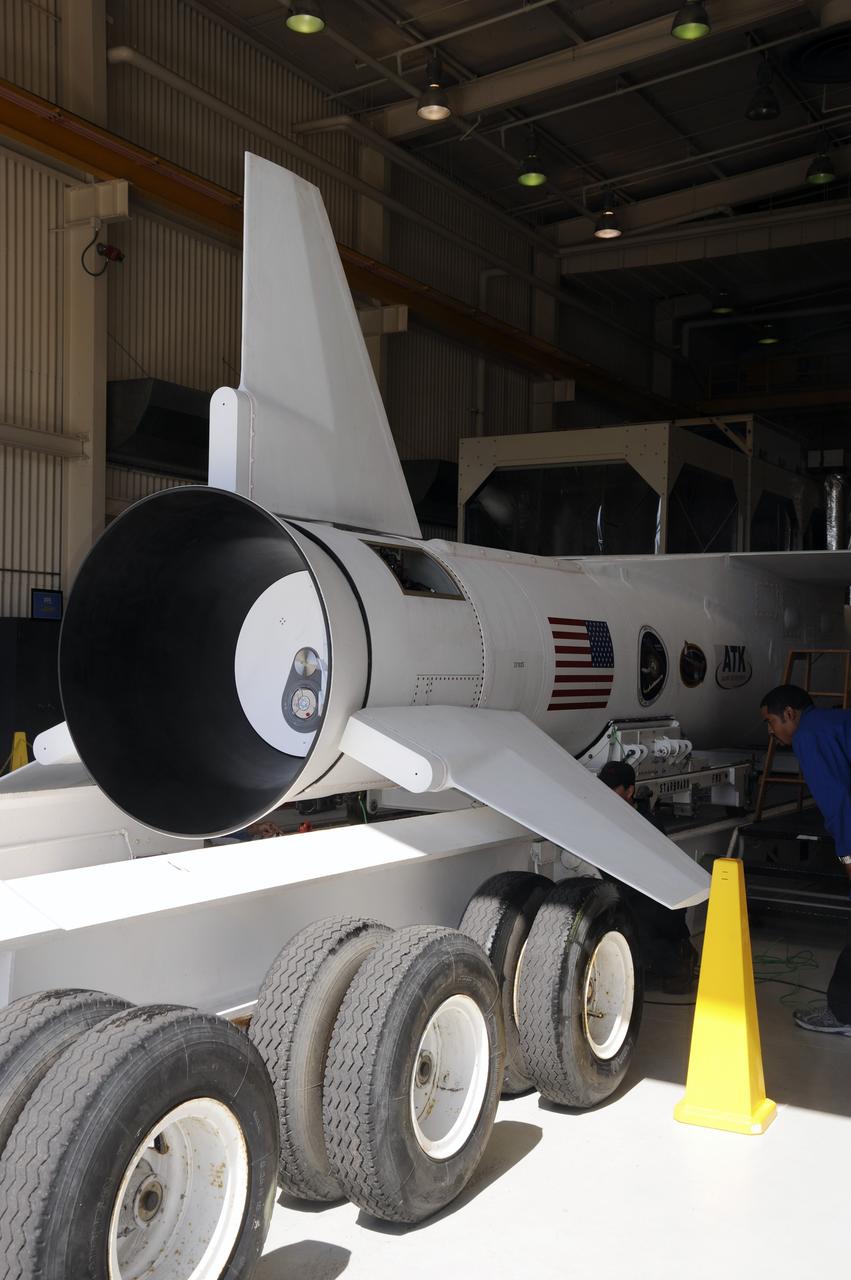 VANDENBERG AIR FORCE BASE, Calif. – At Vandenberg Air Force Base in California, a transporter is moved underneath the Orbital Science’s Pegasus XL inside Orbital’s hangar. The rocket is mated to NASA’s encapsulated Nuclear Spectroscopic Telescope Array, or NuSTAR, out of sight inside the hangar. The transporter will move them to the runway ramp where they will be attached to the underside of Orbital’s L-1011 carrier aircraft. The aircraft will fly the pair from Vandenberg to the Ronald Reagan Ballistic Missile Defense Test Site on the Pacific Ocean’s Kwajalein Atoll for launch. A revised launch date is expected to be set at the Flight Readiness Review. The high-energy X-ray telescope will conduct a census of black holes, map radioactive material in young supernovae remnants, and study the origins of cosmic rays and the extreme physics around collapsed stars. For more information, visit http://www.nasa.gov/nustar. Photo credit: NASA/Mark Mackiey