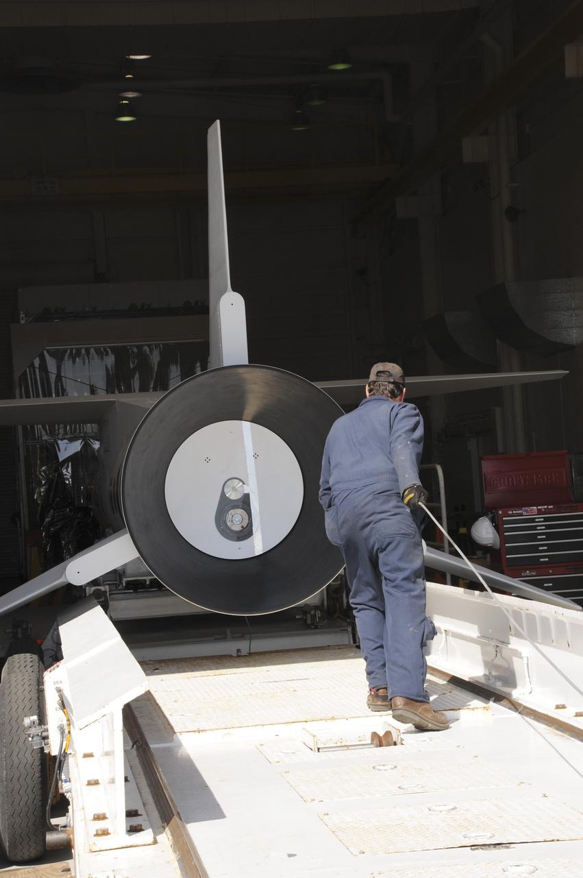 VANDENBERG AIR FORCE BASE, Calif. – At Vandenberg Air Force Base in California, a technician monitors the progress as a transporter is moved underneath the Orbital Science’s Pegasus XL inside Orbital’s hangar. The rocket is mated to NASA’s encapsulated Nuclear Spectroscopic Telescope Array, or NuSTAR, out of sight inside the hangar. The transporter will move them to the runway ramp where they will be attached to the underside of Orbital’s L-1011 carrier aircraft. The aircraft will fly the pair from Vandenberg to the Ronald Reagan Ballistic Missile Defense Test Site on the Pacific Ocean’s Kwajalein Atoll for launch. A revised launch date is expected to be set at the Flight Readiness Review. The high-energy X-ray telescope will conduct a census of black holes, map radioactive material in young supernovae remnants, and study the origins of cosmic rays and the extreme physics around collapsed stars. For more information, visit http://www.nasa.gov/nustar. Photo credit: NASA/Mark Mackiey