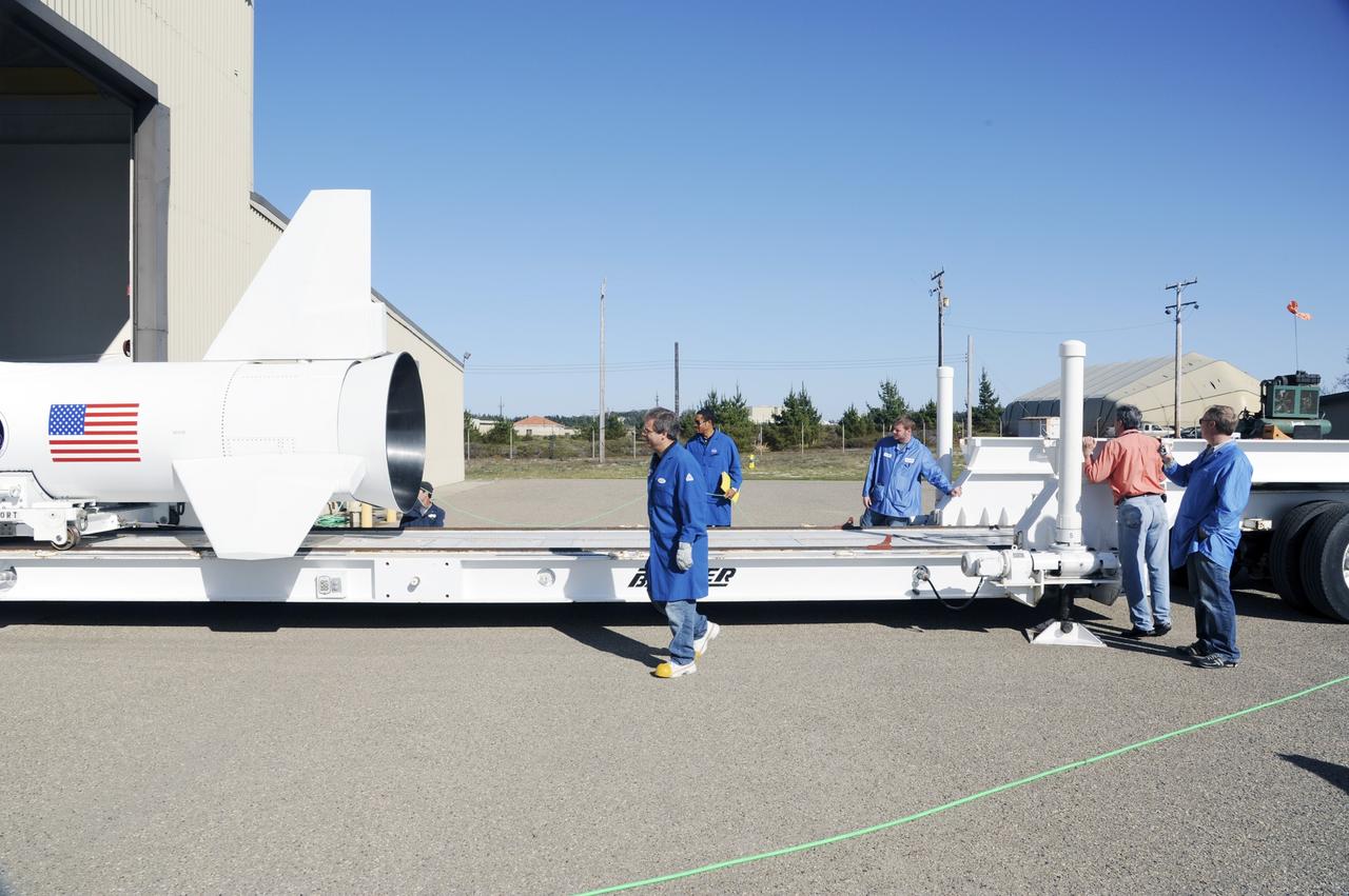 VANDENBERG AIR FORCE BASE, Calif. – At Vandenberg Air Force Base in California, technicians monitor the progress as the Orbital Science’s Pegasus XL is moved onto a transporter inside Orbital’s hangar. The rocket is mated to NASA’s encapsulated Nuclear Spectroscopic Telescope Array, or NuSTAR, out of sight inside the hangar. The transporter will move them to the runway ramp where they will be attached to the underside of Orbital’s L-1011 carrier aircraft. The aircraft will fly the pair from Vandenberg to the Ronald Reagan Ballistic Missile Defense Test Site on the Pacific Ocean’s Kwajalein Atoll for launch. A revised launch date is expected to be set at the Flight Readiness Review. The high-energy X-ray telescope will conduct a census of black holes, map radioactive material in young supernovae remnants, and study the origins of cosmic rays and the extreme physics around collapsed stars. For more information, visit http://www.nasa.gov/nustar. Photo credit: NASA/Mark Mackiey