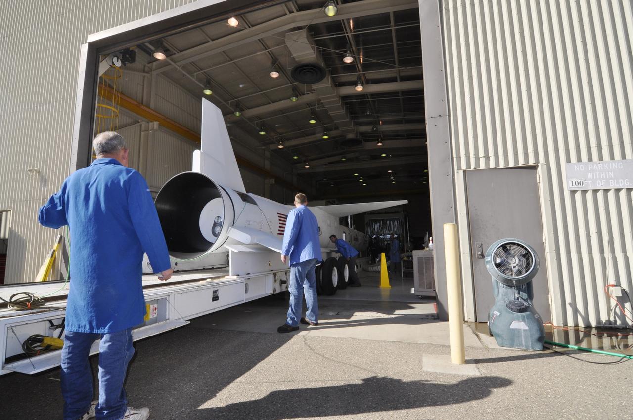 VANDENBERG AIR FORCE BASE, Calif. – At Vandenberg Air Force Base in California, technicians monitor the progress as a transporter is moved underneath the Orbital Science’s Pegasus XL inside Orbital’s hangar. The rocket is mated to NASA’s encapsulated Nuclear Spectroscopic Telescope Array, or NuSTAR, out of sight inside the hangar. The transporter will move them to the runway ramp where they will be attached to the underside of Orbital’s L-1011 carrier aircraft. The aircraft will fly the pair from Vandenberg to the Ronald Reagan Ballistic Missile Defense Test Site on the Pacific Ocean’s Kwajalein Atoll for launch. A revised launch date is expected to be set at the Flight Readiness Review. The high-energy X-ray telescope will conduct a census of black holes, map radioactive material in young supernovae remnants, and study the origins of cosmic rays and the extreme physics around collapsed stars. For more information, visit http://www.nasa.gov/nustar. Photo credit: NASA/Randy Beaudoin