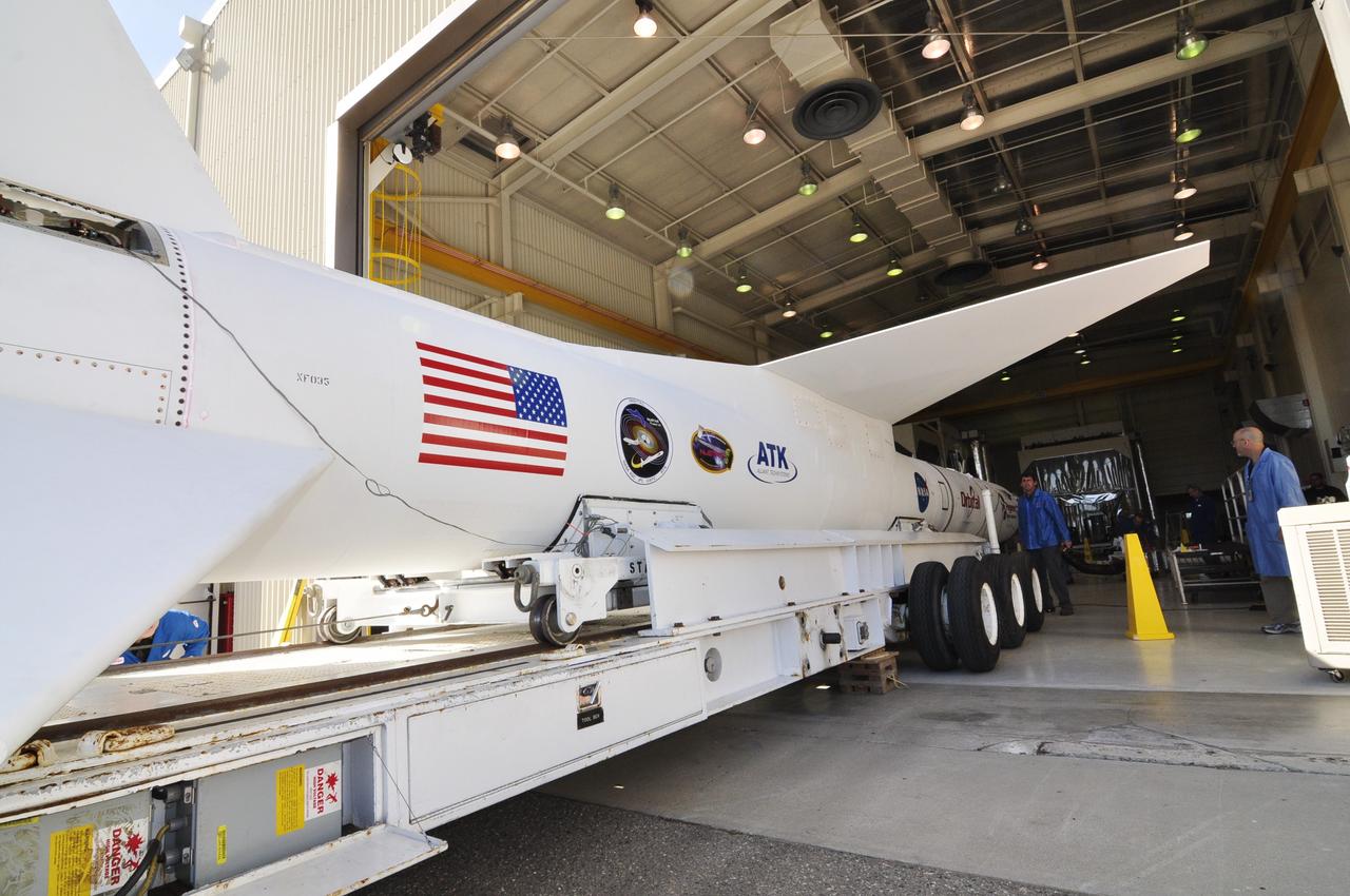 VANDENBERG AIR FORCE BASE, Calif. – At Vandenberg Air Force Base in California, technicians monitor the progress as a transporter is moved underneath the Orbital Science’s Pegasus XL inside Orbital’s hangar. The rocket is mated to NASA’s encapsulated Nuclear Spectroscopic Telescope Array, or NuSTAR, spacecraft. The transporter will move them to the runway ramp where they will be attached to the underside of Orbital’s L-1011 carrier aircraft. The aircraft will fly the pair from Vandenberg to the Ronald Reagan Ballistic Missile Defense Test Site on the Pacific Ocean’s Kwajalein Atoll for launch. A revised launch date is expected to be set at the Flight Readiness Review. The high-energy X-ray telescope will conduct a census of black holes, map radioactive material in young supernovae remnants, and study the origins of cosmic rays and the extreme physics around collapsed stars. For more information, visit http://www.nasa.gov/nustar. Photo credit: NASA/Randy Beaudoin