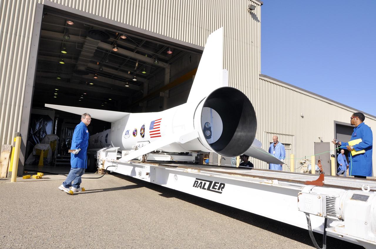 VANDENBERG AIR FORCE BASE, Calif. – At Vandenberg Air Force Base in California, technicians monitor the progress as a transporter is moved underneath the Orbital Science’s Pegasus XL at Orbital’s hangar. The rocket is mated to NASA’s encapsulated Nuclear Spectroscopic Telescope Array, or NuSTAR, spacecraft. The transporter will move them to the runway ramp where they will be attached to the underside of Orbital’s L-1011 carrier aircraft. The aircraft will fly the pair from Vandenberg to the Ronald Reagan Ballistic Missile Defense Test Site on the Pacific Ocean’s Kwajalein Atoll for launch. A revised launch date is expected to be set at the Flight Readiness Review. The high-energy X-ray telescope will conduct a census of black holes, map radioactive material in young supernovae remnants, and study the origins of cosmic rays and the extreme physics around collapsed stars. For more information, visit http://www.nasa.gov/nustar. Photo credit: NASA/Randy Beaudoin