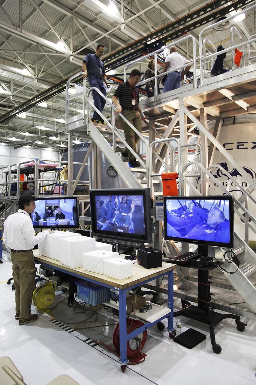 HAWTHORNE, Calif. -- NASA astronauts and industry experts are monitored while they check out the crew accommodations in the Dragon spacecraft under development by Space Exploration Technologies SpaceX of Hawthorne, Calif., for the agency's Commercial Crew Program. In 2011, NASA selected SpaceX during Commercial Crew Development Round 2 CCDev2) activities to mature the design and development of a crew transportation system with the overall goal of accelerating a United States-led capability to the International Space Station. The goal of CCP is to drive down the cost of space travel as well as open up space to more people than ever before by balancing industry’s own innovative capabilities with NASA's 50 years of human spaceflight experience. Six other aerospace companies also are maturing launch vehicle and spacecraft designs under CCDev2, including Alliant Techsystems Inc. ATK, The Boeing Co., Excalibur Almaz Inc., Blue Origin, Sierra Nevada, and United Launch Alliance ULA. For more information, visit www.nasa.gov/commercialcrew. Image credit: Space Exploration Technologies