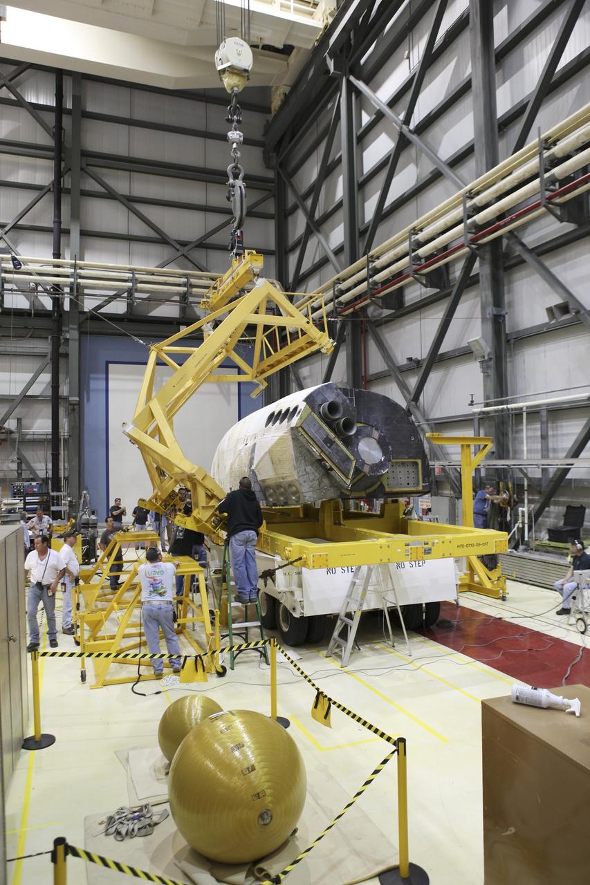 CAPE CANAVERAL, Fla. -- In Orbiter Processing Facility-2 at NASA's Kennedy Space Center in Florida, operations to lift the left orbital maneuvering system OMS pod of space shuttle Endeavour are under way. The OMS pod is being reinstalled on Endeavour following a complete deservicing and cleaning at White Sands Space Harbor in New Mexico, part of the shuttle’s transition and retirement processing. Endeavour is being prepared for public display at the California Science Center in Los Angeles. Over the course of its 19-year career, Endeavour spent 299 days in space during 25 missions. For more information, visit http://www.nasa.gov/shuttle. Photo credit: NASA/Dimitri Gerondidakis