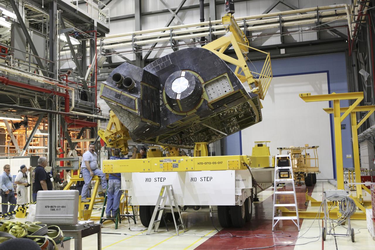 CAPE CANAVERAL, Fla. -- In Orbiter Processing Facility-2 at NASA's Kennedy Space Center in Florida, United Space Alliance technicians lift the left orbital maneuvering system OMS pod of space shuttle Endeavour from its transporter. The OMS pod is being reinstalled on Endeavour following a complete deservicing and cleaning at White Sands Space Harbor in New Mexico, part of the shuttle’s transition and retirement processing. Endeavour is being prepared for public display at the California Science Center in Los Angeles. Over the course of its 19-year career, Endeavour spent 299 days in space during 25 missions. For more information, visit http://www.nasa.gov/shuttle. Photo credit: NASA/Dimitri Gerondidakis
