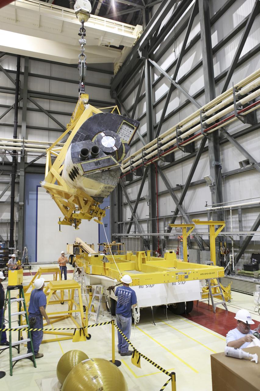 CAPE CANAVERAL, Fla. -- In Orbiter Processing Facility-2 at NASA's Kennedy Space Center in Florida, United Space Alliance technicians lift and rotate the left orbital maneuvering system OMS pod of space shuttle Endeavour above its transporter. The OMS pod is being reinstalled on Endeavour following a complete deservicing and cleaning at White Sands Space Harbor in New Mexico, part of the shuttle’s transition and retirement processing. Endeavour is being prepared for public display at the California Science Center in Los Angeles. Over the course of its 19-year career, Endeavour spent 299 days in space during 25 missions. For more information, visit http://www.nasa.gov/shuttle. Photo credit: NASA/Dimitri Gerondidakis