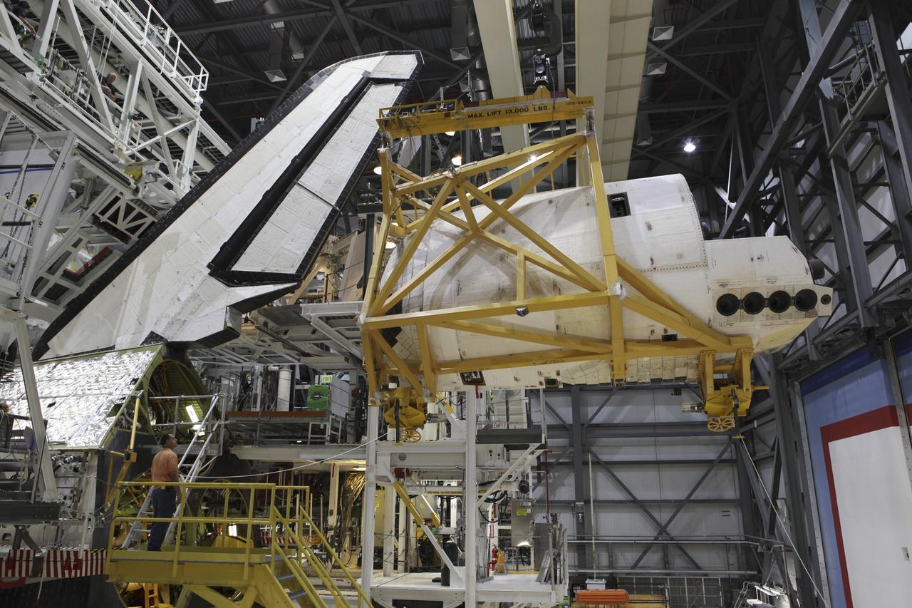CAPE CANAVERAL, Fla. – A crane moves the left orbital maneuvering system OMS pod toward the aft of space shuttle Endeavour in Orbiter Processing Facility-2 at NASA's Kennedy Space Center in Florida. The OMS pod is being reinstalled on Endeavour following a complete deservicing and cleaning at White Sands Space Harbor in New Mexico, part of the shuttle’s transition and retirement processing. Endeavour is being prepared for public display at the California Science Center in Los Angeles. Over the course of its 19-year career, Endeavour spent 299 days in space during 25 missions. For more information, visit http://www.nasa.gov/shuttle. Photo credit: NASA/Dimitri Gerondidakis