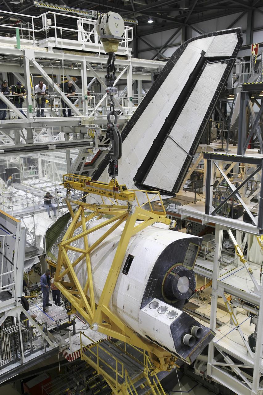CAPE CANAVERAL, Fla. – Space shuttle Endeavour’s left orbital maneuvering system OMS pod is lowered into position on the shuttle in Orbiter Processing Facility-2 at NASA's Kennedy Space Center in Florida. The OMS pod is being reinstalled on Endeavour following a complete deservicing and cleaning at White Sands Space Harbor in New Mexico, part of the shuttle’s transition and retirement processing. Endeavour is being prepared for public display at the California Science Center in Los Angeles. Over the course of its 19-year career, Endeavour spent 299 days in space during 25 missions. For more information, visit http://www.nasa.gov/shuttle. Photo credit: NASA/Dimitri Gerondidakis
