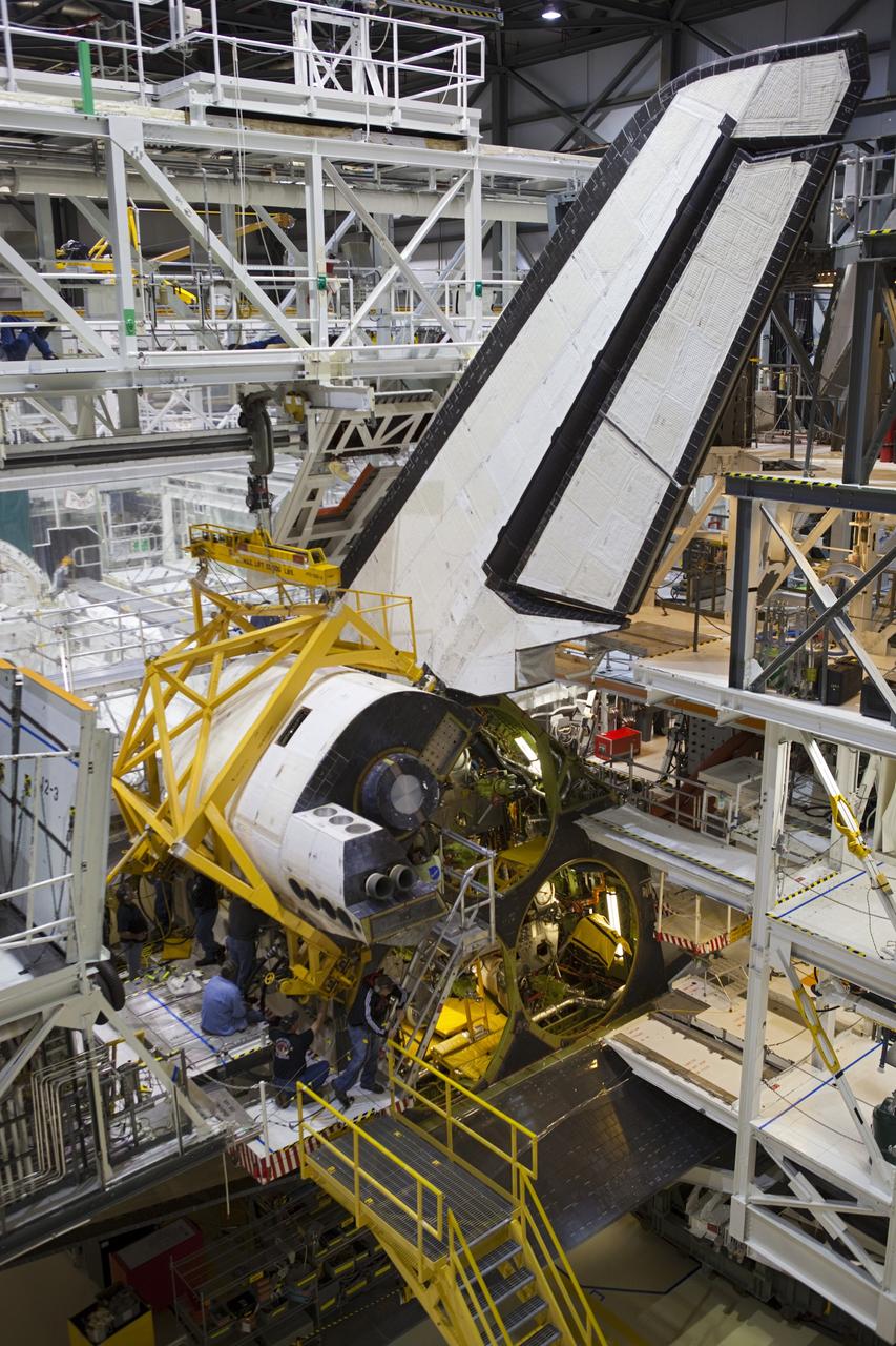 CAPE CANAVERAL, Fla. -- In Orbiter Processing Facility-2 at NASA’s Kennedy Space Center in Florida, United Space Alliance technicians help to install space shuttle Endeavour’s left orbital maneuvering system OMS pod. The OMS pod underwent complete deservicing and cleaning at White Sands Space Harbor in New Mexico, part of the transition and retirement processing of each shuttle. Endeavour is being prepared for public display at the California Science Center in Los Angeles. Over the course of its 19-year career, Endeavour spent 299 days in space during 25 missions. For more information, visit http://www.nasa.gov/shuttle. Photo credit: NASA/Dimitri Gerondidakis