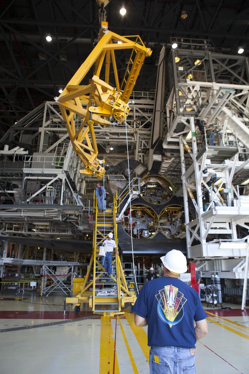 CAPE CANAVERAL, Fla. -- In Orbiter Processing Facility-2 at NASA’s Kennedy Space Center in Florida, a large crane is lifted away from space shuttle Endeavour while United Space Alliance technicians complete the installation of the left orbital maneuvering system OMS pod. The OMS pod underwent complete deservicing and cleaning at White Sands Space Harbor in New Mexico, part of the transition and retirement processing of each shuttle. Endeavour is being prepared for public display at the California Science Center in Los Angeles. Over the course of its 19-year career, Endeavour spent 299 days in space during 25 missions. For more information, visit http://www.nasa.gov/shuttle. Photo credit: NASA/Dimitri Gerondidakis