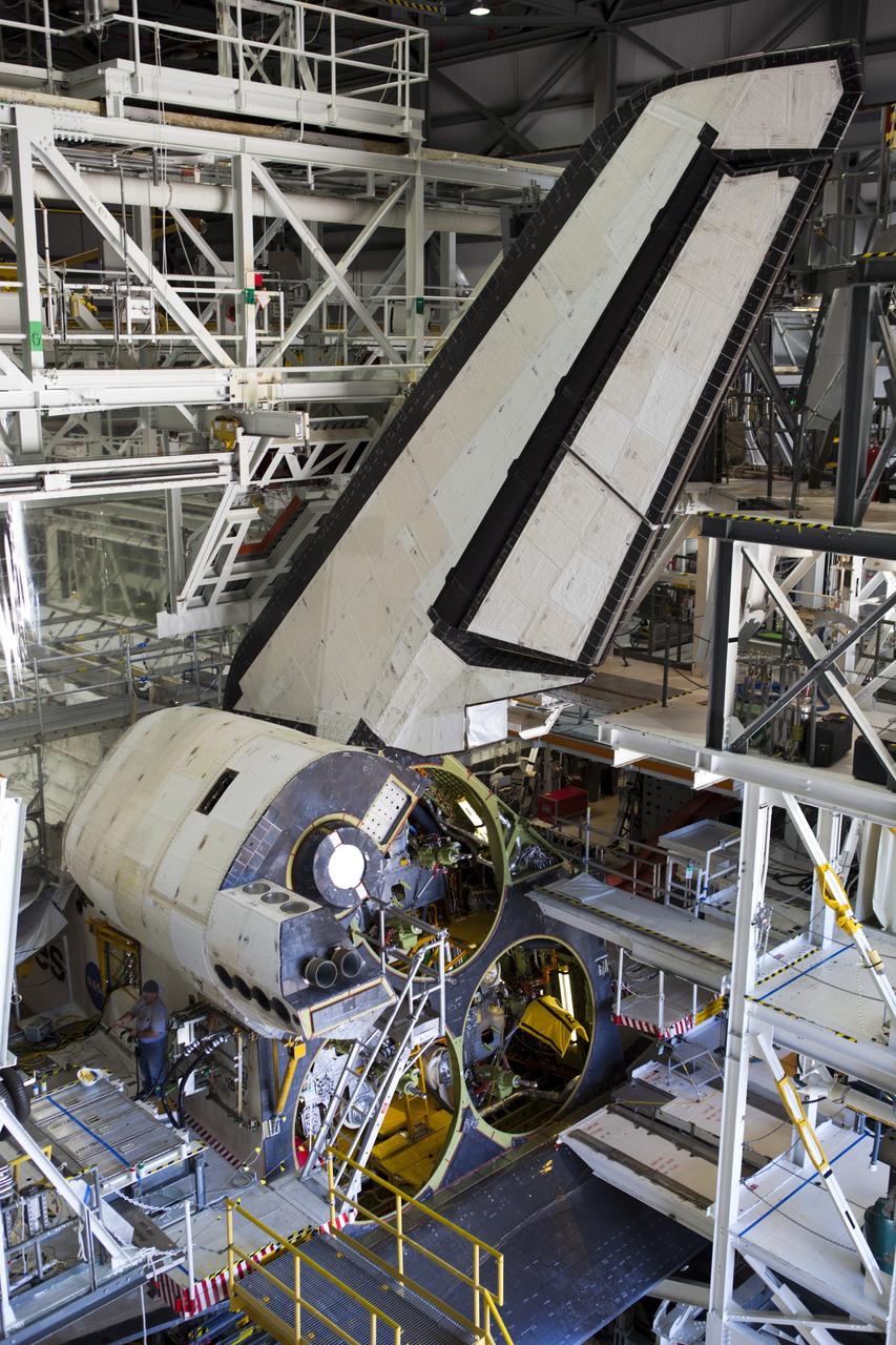 CAPE CANAVERAL, Fla. -- In Orbiter Processing Facility-2 at NASA’s Kennedy Space Center in Florida, United Space Alliance technicians complete the work to install space shuttle Endeavour’s left orbital maneuvering system OMS pod. The OMS pod underwent complete deservicing and cleaning at White Sands Space Harbor in New Mexico, part of the transition and retirement processing of each shuttle. Endeavour is being prepared for public display at the California Science Center in Los Angeles. Over the course of its 19-year career, Endeavour spent 299 days in space during 25 missions. For more information, visit http://www.nasa.gov/shuttle. Photo credit: NASA/Dimitri Gerondidakis