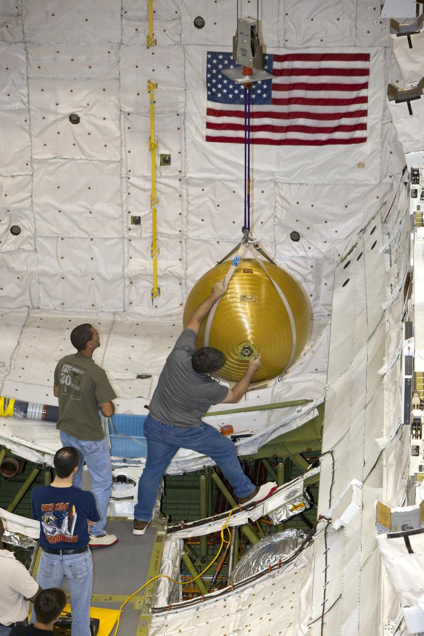 CAPE CANAVERAL, Fla. -- In Orbiter Processing Facility-2 at NASA’s Kennedy Space Center in Florida, United Space Alliance technicians attach one of space shuttle Endeavour’s main propulsion system tanks from the mid-body to an overhead crane for removal. The tanks will be retained for possible future use on the agency’s Space Launch System Program. The work is part of Endeavour’s transition and retirement processing. The spacecraft is being prepared for public display at the California Science Center in Los Angeles. Endeavour flew 25 missions, spent 299 days in space, orbited Earth 4,671 times and traveled 122, 883, 151 miles over the course of its 19-year career. For more information, visit http://www.nasa.gov/shuttle. Photo credit: Dimitri Gerondidakis