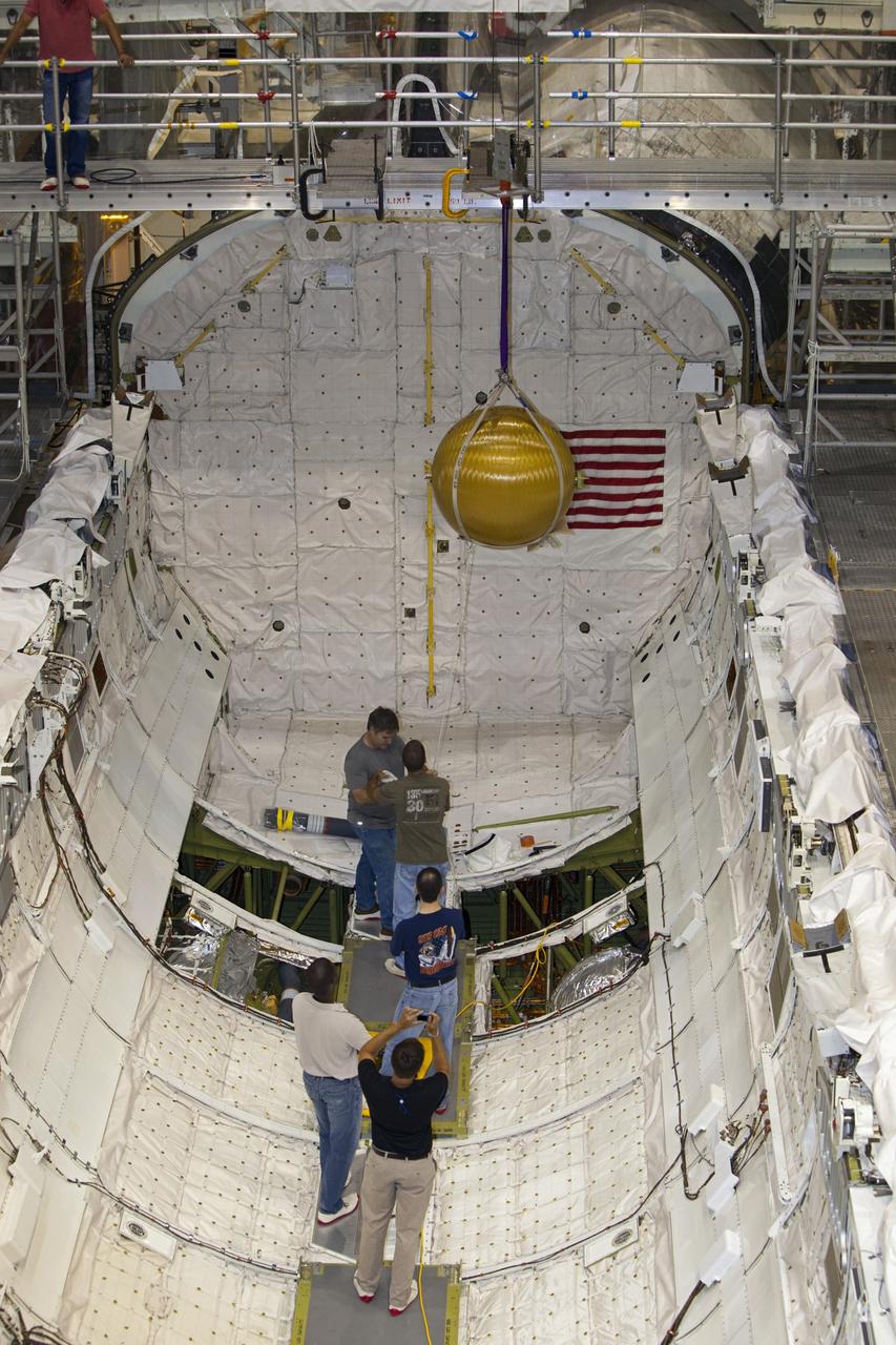 CAPE CANAVERAL, Fla. --In Orbiter Processing Facility-2 at NASA’s Kennedy Space Center in Florida, a crane lifts away one of space shuttle Endeavour’s main propulsion system tanks from the mid-body after it was removed by United Space Alliance technicians. The tanks will be retained for possible future use on the agency’s Space Launch System Program. The work is part of Endeavour’s transition and retirement processing. The spacecraft is being prepared for public display at the California Science Center in Los Angeles. Endeavour flew 25 missions, spent 299 days in space, orbited Earth 4,671 times and traveled 122, 883, 151 miles over the course of its 19-year career. For more information, visit http://www.nasa.gov/shuttle. Photo credit: Dimitri Gerondidakis