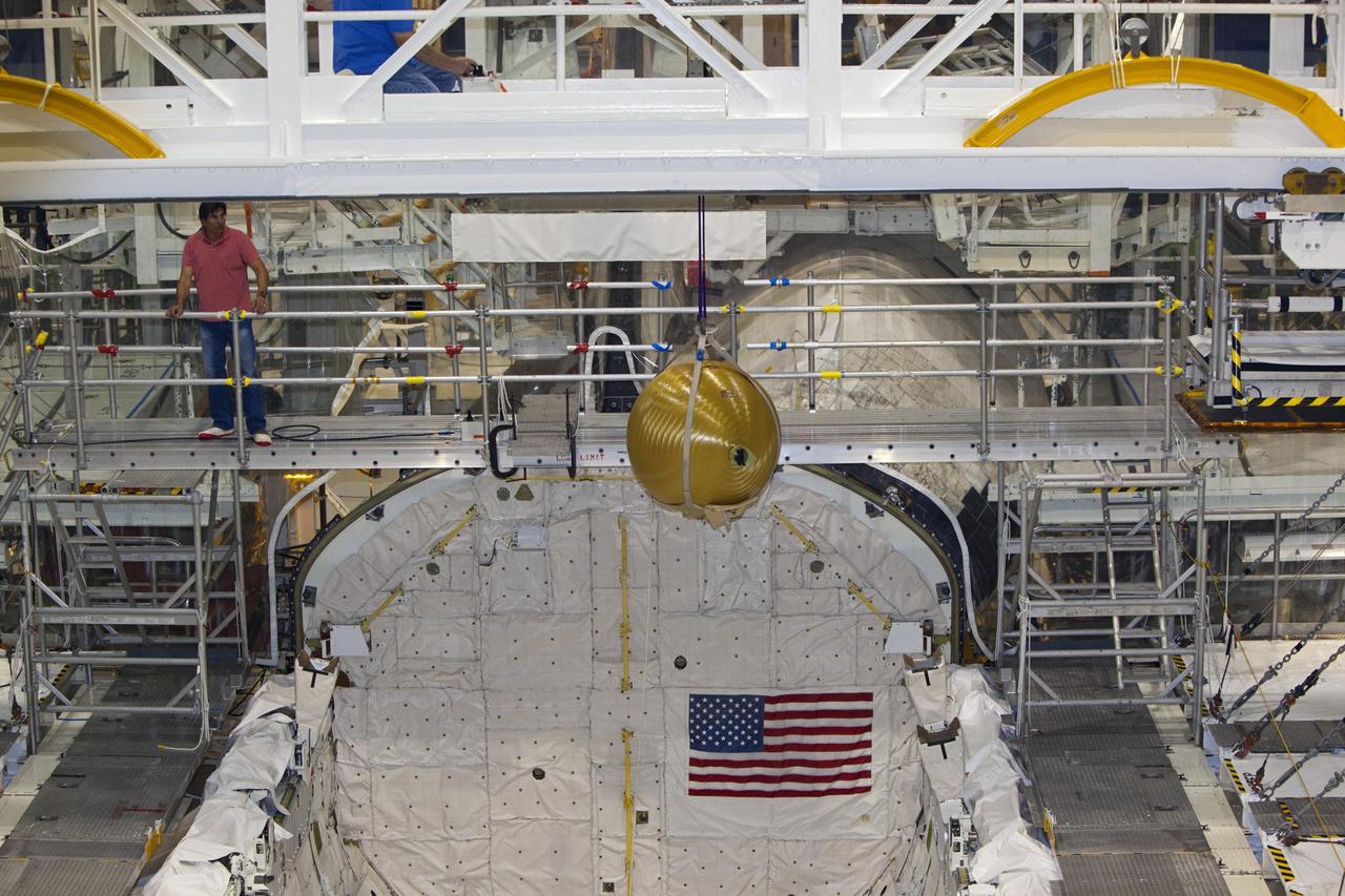 CAPE CANAVERAL, Fla. -- In Orbiter Processing Facility-2 at NASA’s Kennedy Space Center in Florida, a United Space Alliance technician monitors the progress as an overhead crane moves one of Endeavour’s main propulsion system tanks away from the mid-body of the orbiter. The tanks will be retained for possible future use on the agency’s Space Launch System Program. The work is part of Endeavour’s transition and retirement processing. The spacecraft is being prepared for public display at the California Science Center in Los Angeles. Endeavour flew 25 missions, spent 299 days in space, orbited Earth 4,671 times and traveled 122, 883, 151 miles over the course of its 19-year career. For more information, visit http://www.nasa.gov/shuttle. Photo credit: Dimitri Gerondidakis
