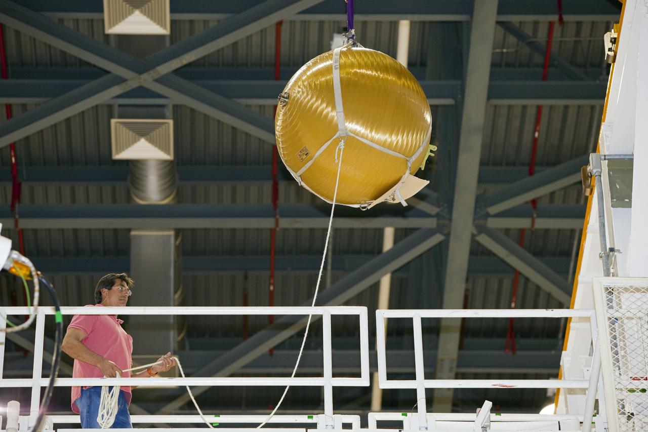 CAPE CANAVERAL, Fla. -- In Orbiter Processing Facility-2 at NASA’s Kennedy Space Center in Florida, a United Space Alliance technician monitors the progress as an overhead crane moves one of Endeavour’s main propulsion system tanks away from the mid-body of the orbiter. The tanks will be retained for possible future use on the agency’s Space Launch System Program. The work is part of Endeavour’s transition and retirement processing. The spacecraft is being prepared for public display at the California Science Center in Los Angeles. Endeavour flew 25 missions, spent 299 days in space, orbited Earth 4,671 times and traveled 122, 883, 151 miles over the course of its 19-year career. For more information, visit http://www.nasa.gov/shuttle. Photo credit: Dimitri Gerondidakis