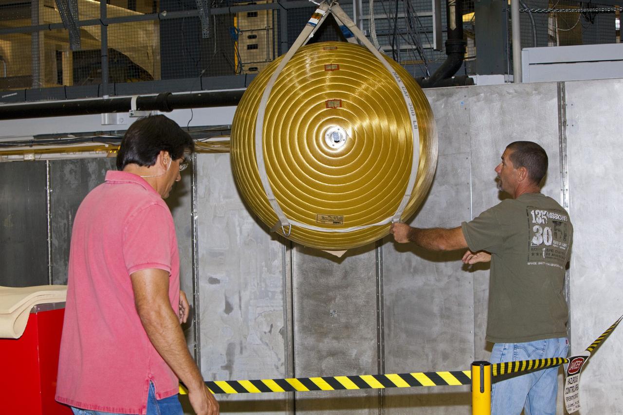 CAPE CANAVERAL, Fla. -- In Orbiter Processing Facility-2 at NASA’s Kennedy Space Center in Florida, United Space Alliance technicians monitor the progress as an overhead crane lowers one of Endeavour’s main propulsion system tanks after it was removed from the orbiter’s mid-body. The tanks will be retained for possible future use on the agency’s Space Launch System Program. The work is part of Endeavour’s transition and retirement processing. The spacecraft is being prepared for public display at the California Science Center in Los Angeles. Endeavour flew 25 missions, spent 299 days in space, orbited Earth 4,671 times and traveled 122, 883, 151 miles over the course of its 19-year career. For more information, visit http://www.nasa.gov/shuttle. Photo credit: Dimitri Gerondidakis