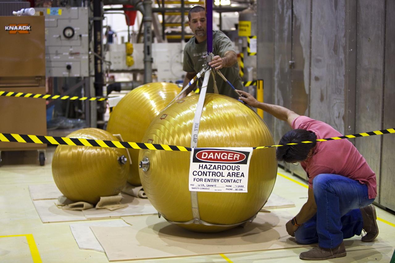 CAPE CANAVERAL, Fla. -- In Orbiter Processing Facility-2 at NASA’s Kennedy Space Center in Florida, United Space Alliance technicians secure several of space shuttle Endeavour’s main propulsion system tanks after they were removed from the orbiter’s mid-body. The tanks will be retained for possible future use on the agency’s Space Launch System Program. The work is part of Endeavour’s transition and retirement processing. The spacecraft is being prepared for public display at the California Science Center in Los Angeles. Endeavour flew 25 missions, spent 299 days in space, orbited Earth 4,671 times and traveled 122, 883, 151 miles over the course of its 19-year career. For more information, visit http://www.nasa.gov/shuttle. Photo credit: Dimitri Gerondidakis