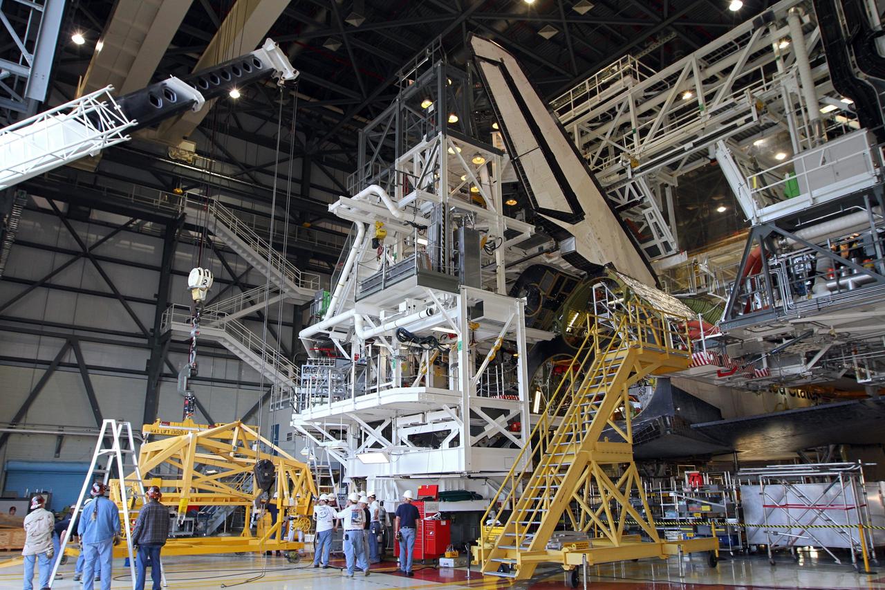 CAPE CANAVERAL, Fla. – In Orbiter Processing Facility-2 at NASA’s Kennedy Space Center in Florida, United Space Alliance technicians prepare a large crane that will lift the right orbital maneuvering system OMS pod for installation on space shuttle Endeavour. The OMS pod underwent complete deservicing and cleaning at White Sands Space Harbor in New Mexico, part of the transition and retirement processing of each shuttle. Endeavour is being prepared for public display at the California Science Center in Los Angeles. Over the course of its 19-year career, Endeavour spent 299 days in space during 25 missions. For more information, visit http://www.nasa.gov/shuttle. Photo credit: NASA/Kim Shiflett