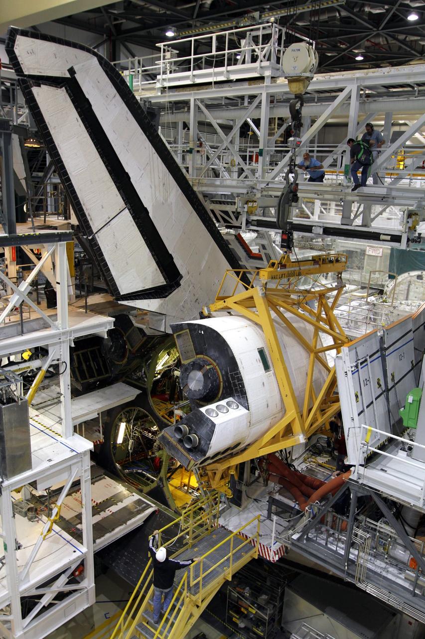 CAPE CANAVERAL, Fla. – In Orbiter Processing Facility-2 at NASA’s Kennedy Space Center in Florida, a large crane has lowered the right orbital maneuvering system OMS pod for installation on space shuttle Endeavour. The OMS pod underwent complete deservicing and cleaning at White Sands Space Harbor in New Mexico, part of the transition and retirement processing of each shuttle. Endeavour is being prepared for public display at the California Science Center in Los Angeles. Over the course of its 19-year career, Endeavour spent 299 days in space during 25 missions. For more information, visit http://www.nasa.gov/shuttle. Photo credit: NASA/Kim Shiflett