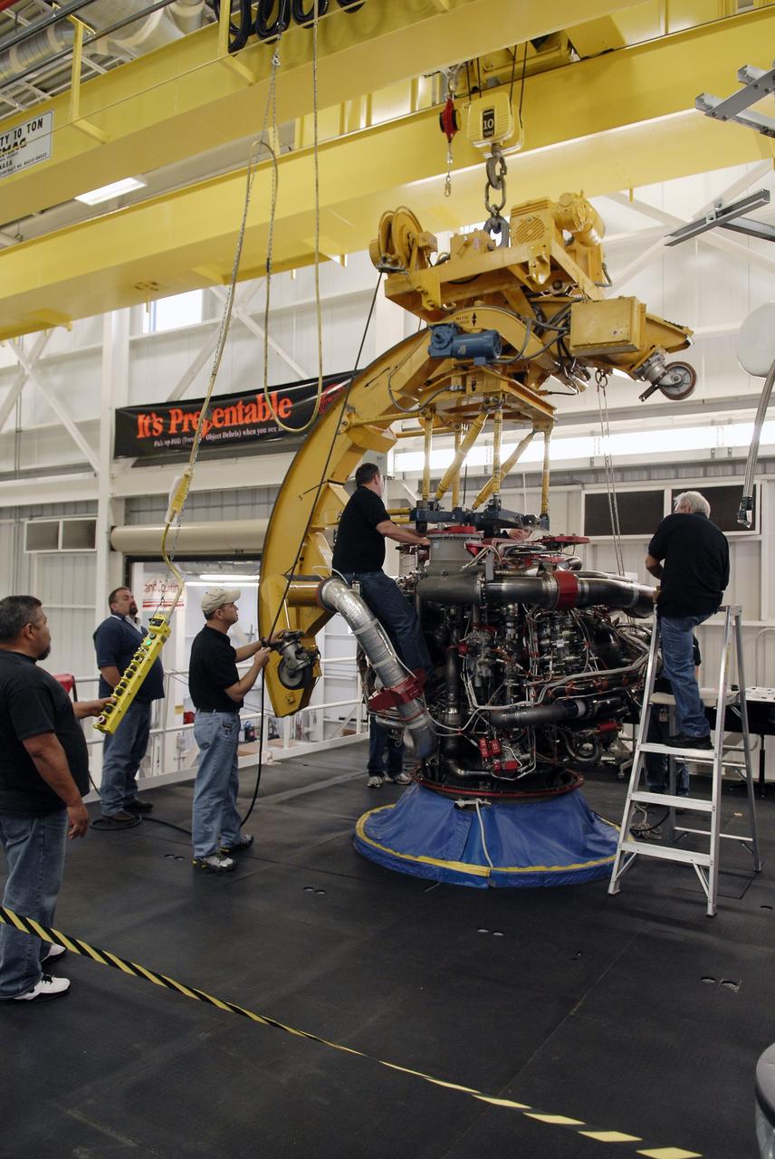 CAPE CANAVERAL, Fla. – Technicians attach a Pratt and Whitney Rocketdyne space shuttle main engine, or SSME, to an engine-handling device inside the SSME Processing Facility, the engine shop at NASA’s Kennedy Space Center in Florida.  Preparations are under way to rotate the engine into a horizontal position on a portable workstand.    The engine is one of the last SSMEs remaining at Kennedy and is being prepared for shipment to NASA's Stennis Space Center in Mississippi. The first two groups of engines were shipped from Kennedy to Stennis in November 2011 and January 2012 the remaining engines are scheduled to depart on April 9.  Altogether, 15 shuttle-era engines will be stored at Stennis for reuse on NASA’s Space Launch System heavy-lift rocket, under development. Photo credit: NASA/Tim Jacobs