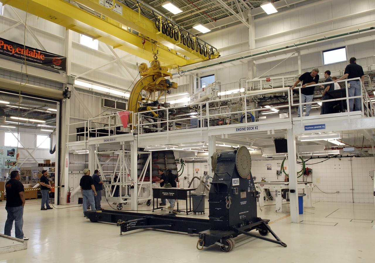 CAPE CANAVERAL, Fla. – Technicians monitor a Pratt and Whitney Rocketdyne space shuttle main engine, or SSME, as a crane lifts it off its base inside the SSME Processing Facility, the engine shop at NASA’s Kennedy Space Center in Florida.  Operations are under way to rotate the engine into a horizontal position on a portable workstand.    The engine is one of the last SSMEs remaining at Kennedy and is being prepared for shipment to NASA's Stennis Space Center in Mississippi. The first two groups of engines were shipped from Kennedy to Stennis in November 2011 and January 2012 the remaining engines are scheduled to depart on April 9.  Altogether, 15 shuttle-era engines will be stored at Stennis for reuse on NASA’s Space Launch System heavy-lift rocket, under development. Photo credit: NASA/Tim Jacobs