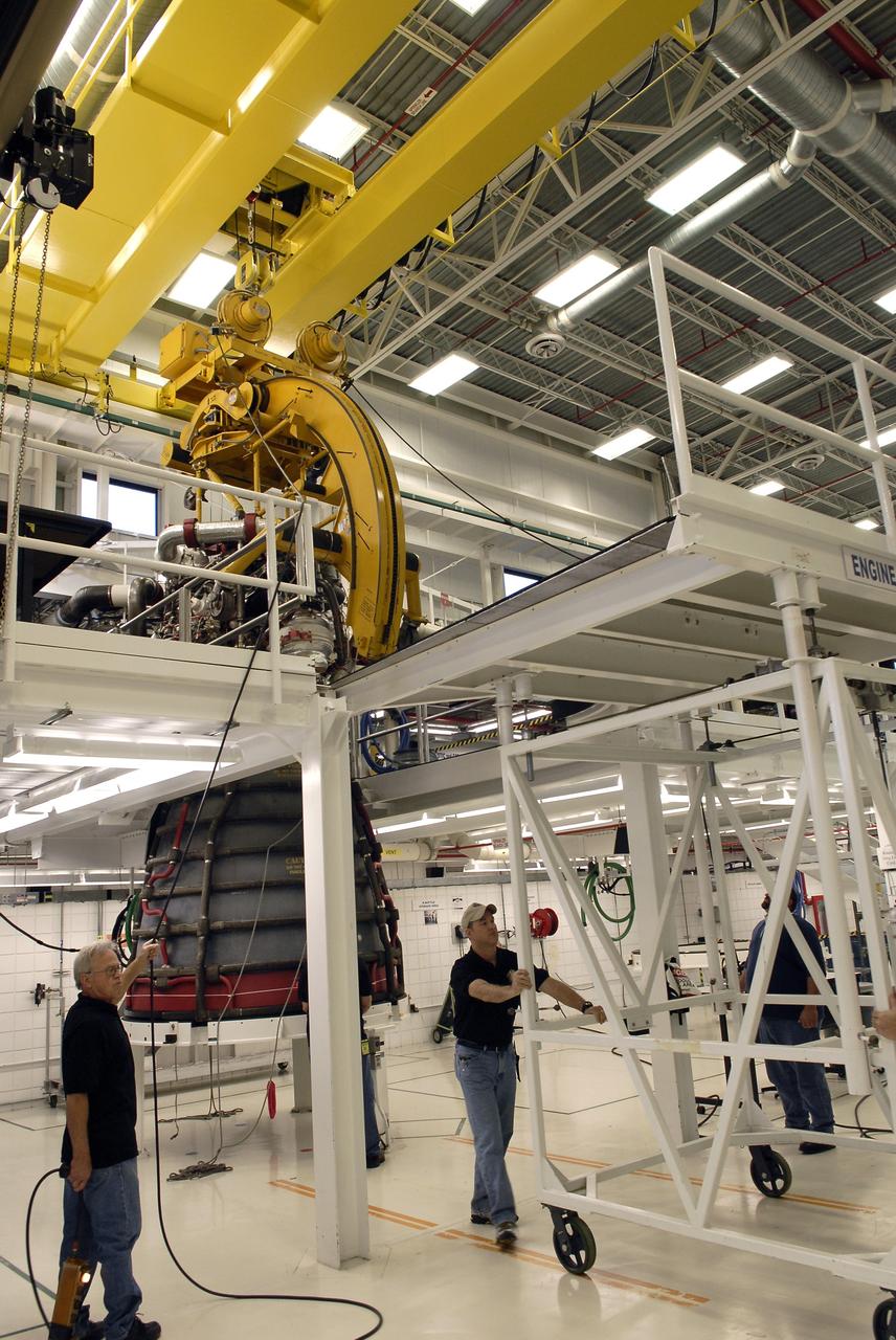 CAPE CANAVERAL, Fla. – Technicians move the work platforms away from a Pratt and Whitney Rocketdyne space shuttle main engine, or SSME, hanging above the floor inside the SSME Processing Facility, the engine shop at NASA’s Kennedy Space Center in Florida.  Operations are under way to rotate the engine into a horizontal position on a portable workstand.    The engine is one of the last SSMEs remaining at Kennedy and is being prepared for shipment to NASA's Stennis Space Center in Mississippi. The first two groups of engines were shipped from Kennedy to Stennis in November 2011 and January 2012 the remaining engines are scheduled to depart on April 9.  Altogether, 15 shuttle-era engines will be stored at Stennis for reuse on NASA’s Space Launch System heavy-lift rocket, under development. Photo credit: NASA/Tim Jacobs