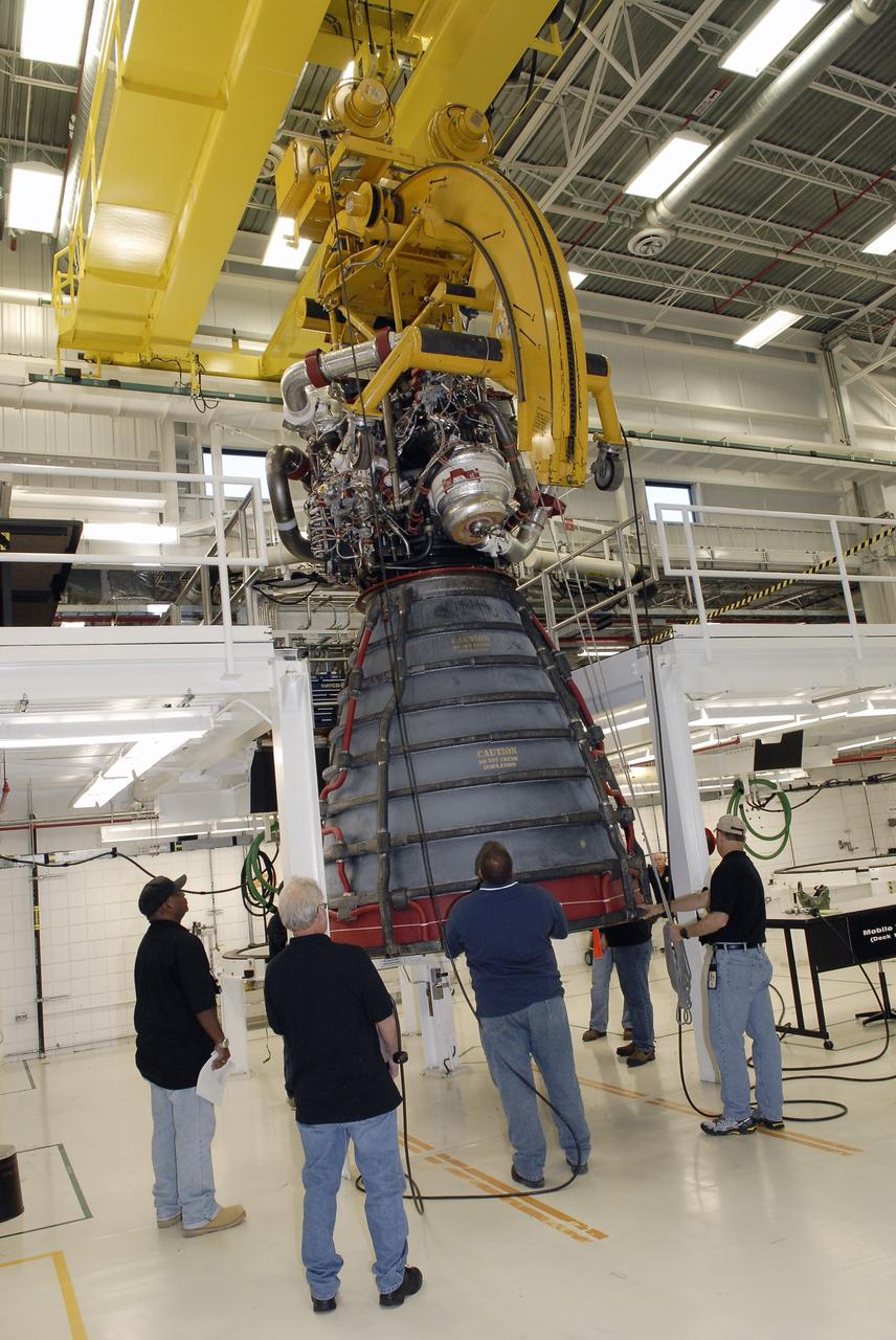 CAPE CANAVERAL, Fla. – A crane moves a Pratt and Whitney Rocketdyne space shuttle main engine, or SSME, across the floor away from the work platforms inside the SSME Processing Facility, the engine shop at NASA’s Kennedy Space Center in Florida.  Operations are under way to rotate the engine into a horizontal position on a portable workstand.    The engine is one of the last SSMEs remaining at Kennedy and is being prepared for shipment to NASA's Stennis Space Center in Mississippi. The first two groups of engines were shipped from Kennedy to Stennis in November 2011 and January 2012 the remaining engines are scheduled to depart on April 9.  Altogether, 15 shuttle-era engines will be stored at Stennis for reuse on NASA’s Space Launch System heavy-lift rocket, under development. Photo credit: NASA/Tim Jacobs