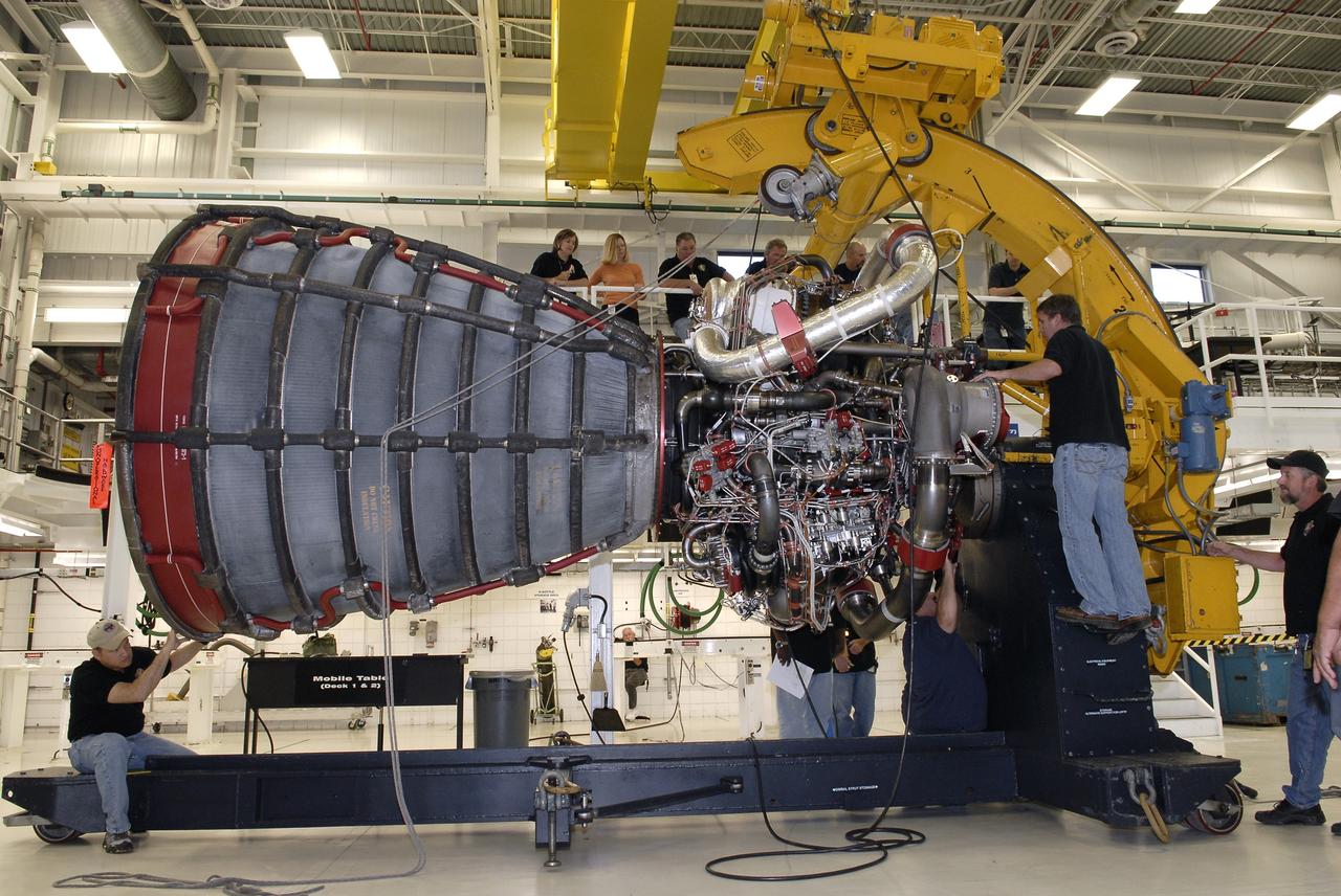 CAPE CANAVERAL, Fla. – Technicians secure a Pratt and Whitney Rocketdyne space shuttle main engine, or SSME, onto a portable workstand inside the SSME Processing Facility, the engine shop at NASA’s Kennedy Space Center in Florida.  The engine was rotated into a horizontal position with the aid of an engine-handling device attached to a crane.    The engine is one of the last SSMEs remaining at Kennedy and is being prepared for shipment to NASA's Stennis Space Center in Mississippi. The first two groups of engines were shipped from Kennedy to Stennis in November 2011 and January 2012 the remaining engines are scheduled to depart on April 9.  Altogether, 15 shuttle-era engines will be stored at Stennis for reuse on NASA’s Space Launch System heavy-lift rocket, under development. Photo credit: NASA/Tim Jacobs