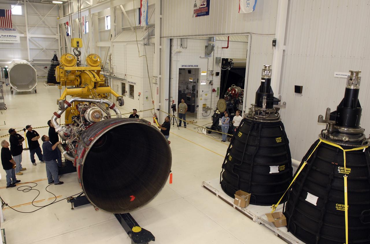 CAPE CANAVERAL, Fla. – Technicians release a crane from an engine-handling device and the Pratt and Whitney Rocketdyne space shuttle main engine, or SSME, that it rotated into a horizontal position inside the SSME Processing Facility, the engine shop at NASA’s Kennedy Space Center in Florida. The engine is secured on a portable workstand before being transferred into a transportation canister.    The engine is one of the last SSMEs remaining at Kennedy and is being prepared for shipment to NASA's Stennis Space Center in Mississippi. The first two groups of engines were shipped from Kennedy to Stennis in November 2011 and January 2012 the remaining engines are scheduled to depart on April 9.  Altogether, 15 shuttle-era engines will be stored at Stennis for reuse on NASA’s Space Launch System heavy-lift rocket, under development. Photo credit: NASA/Tim Jacobs