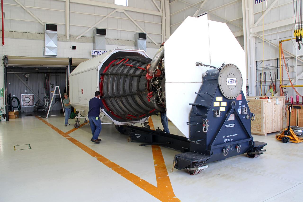 CAPE CANAVERAL, Fla. -- Jeff Huie of Pratt and Whitney Rocketdyne monitors the progress of a space shuttle main engine, or SSME, as it is loaded into a transportation canister in the Orbiter Processing Facility-3 engine shop at NASA's Kennedy Space Center in Florida. The engine is the last to be packed for shipment to NASA's Stennis Space Center in Mississippi.     The first two groups of engines were shipped from Kennedy to Stennis in November 2011 and January 2012, and the remaining engines are scheduled to depart on April 9. Altogether, 15 shuttle-era engines will be stored at Stennis for reuse on NASA’s Space Launch System heavy-lift rocket, under development. Photo credit: NASA/Cory Huston