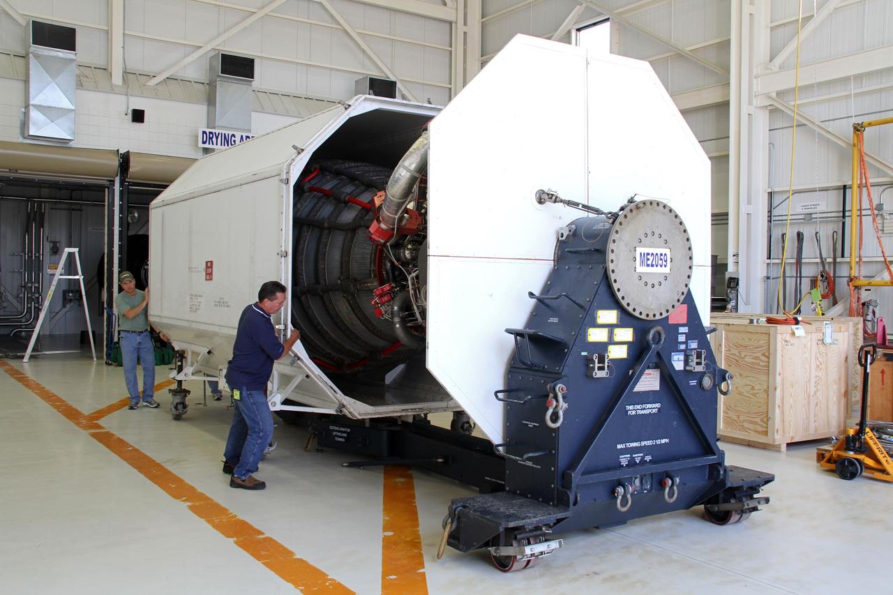 CAPE CANAVERAL, Fla. -- In the Orbiter Processing Facility-3 engine shop at NASA's Kennedy Space Center in Florida, a space shuttle main engine, or SSME, enters a transportation canister under the watchful eyes of Pratt and Whitney Rocketdyne's Jeff Huie. The engine is the last to be packed for shipment to NASA's Stennis Space Center in Mississippi.      The first two groups of engines were shipped from Kennedy to Stennis in November 2011 and January 2012, and the remaining engines are scheduled to depart on April 9. Altogether, 15 shuttle-era engines will be stored at Stennis for reuse on NASA’s Space Launch System heavy-lift rocket, under development. Photo credit: NASA/Cory Huston