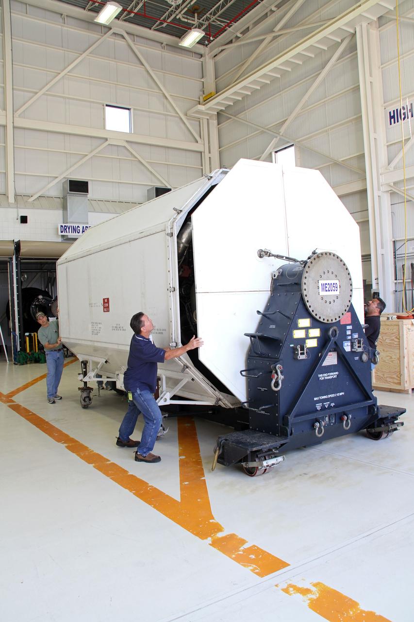 CAPE CANAVERAL, Fla. -- Jeff Huie of Pratt and Whitney Rocketdyne watches as the last of the space shuttle main engines disappears into a transportation canister in the Orbiter Processing Facility-3 engine shop at NASA's Kennedy Space Center in Florida. The engine was packed for shipment to NASA's Stennis Space Center in Mississippi. The first two groups of engines were shipped from Kennedy to Stennis in November 2011 and January 2012, and the remaining engines are scheduled to depart on April 9. Altogether, 15 shuttle-era engines will be stored at Stennis for reuse on NASA’s Space Launch System heavy-lift rocket, under development. Photo credit: NASA/Cory Huston