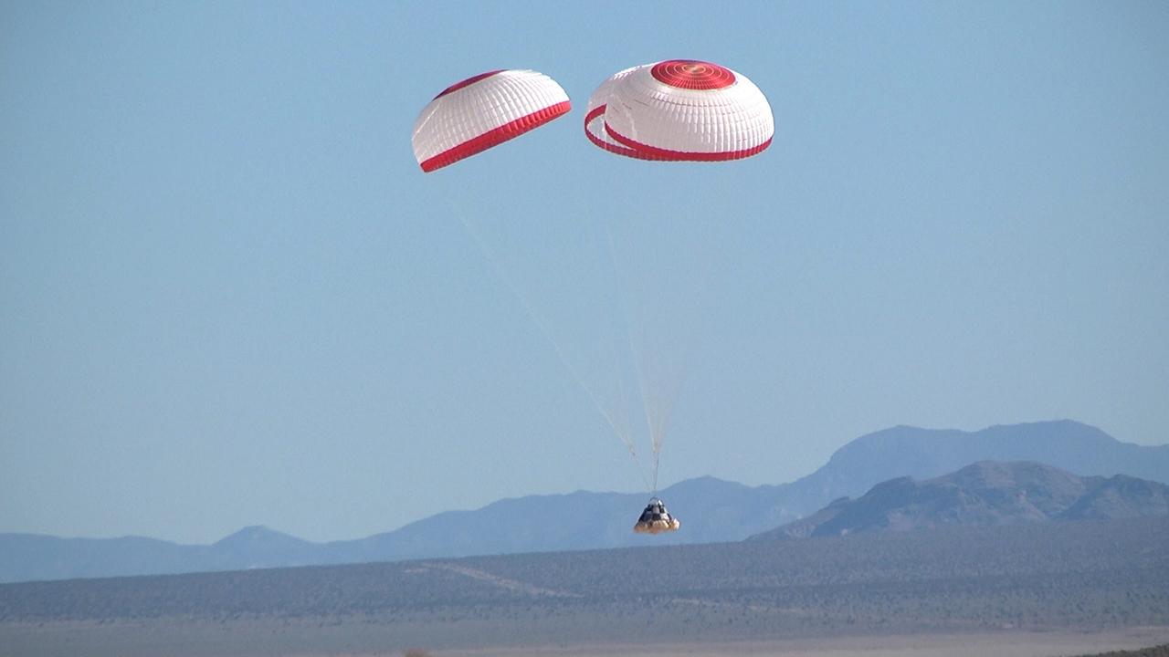DELAMAR DRY LAKE BED, Nev. -- The Boeing Company's CST-100 boilerplate crew capsule floats toward a smooth landing beneath three main parachutes after being released from an Erickson Sky Crane helicopter at about 11,000 feet above Delamar Dry Lake Bed near Alamo, Nev. This is one of two tests that Boeing will perform for NASA's Commercial Crew Program CCP in order to validate the spacecraft's parachute system architecture and deployment scheme, characterize pyrotechnic shock loads, confirm parachute sizing and design, and identify potential forward compartment packaging and deployment issues. In 2011, NASA selected Boeing during Commercial Crew Development Round 2 CCDev2) activities to mature the design and development of a crew transportation system with the overall goal of accelerating a United States-led capability to the International Space Station. The goal of CCP is to drive down the cost of space travel as well as open up space to more people than ever before by balancing industry’s own innovative capabilities with NASA's 50 years of human spaceflight experience. Six other aerospace companies also are maturing launch vehicle and spacecraft designs under CCDev2, including Alliant Techsystems Inc. ATK, Excalibur Almaz Inc., Blue Origin, Sierra Nevada, Space Exploration Technologies SpaceX, and United Launch Alliance ULA. For more information, visit www.nasa.gov/commercialcrew. Image credit: Boeing