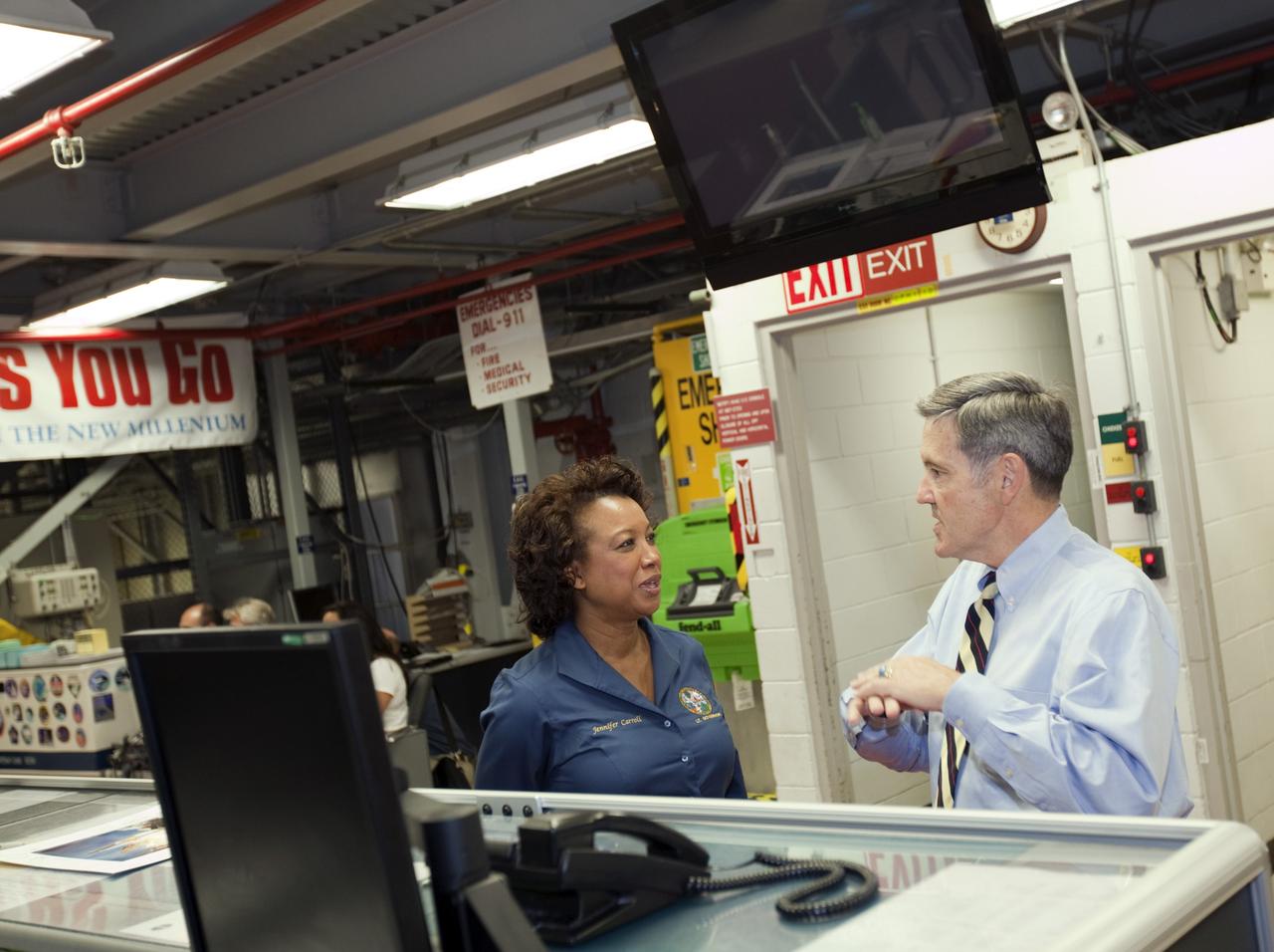 CAPE CANAVERAL, Fla. – Kennedy Space Center Director Bob Cabana, left, briefs Florida’s Lt. Gov. Jennifer Carroll before a tour of Kennedy’s Orbiter Processing Facility-1, the hangar in which space shuttle Atlantis is being prepared for retirement. The tour coincided with Carroll’s visit to Kennedy for a meeting with Cabana. Atlantis is being prepared for public display at the Kennedy Space Center Visitor Complex in 2013. The groundbreaking for Atlantis’ exhibit hall took place in January Atlantis is scheduled to be moved to the visitor complex in November. For more information, visit http://www.nasa.gov/shuttle. Photo credit: NASA/Jim Grossmann