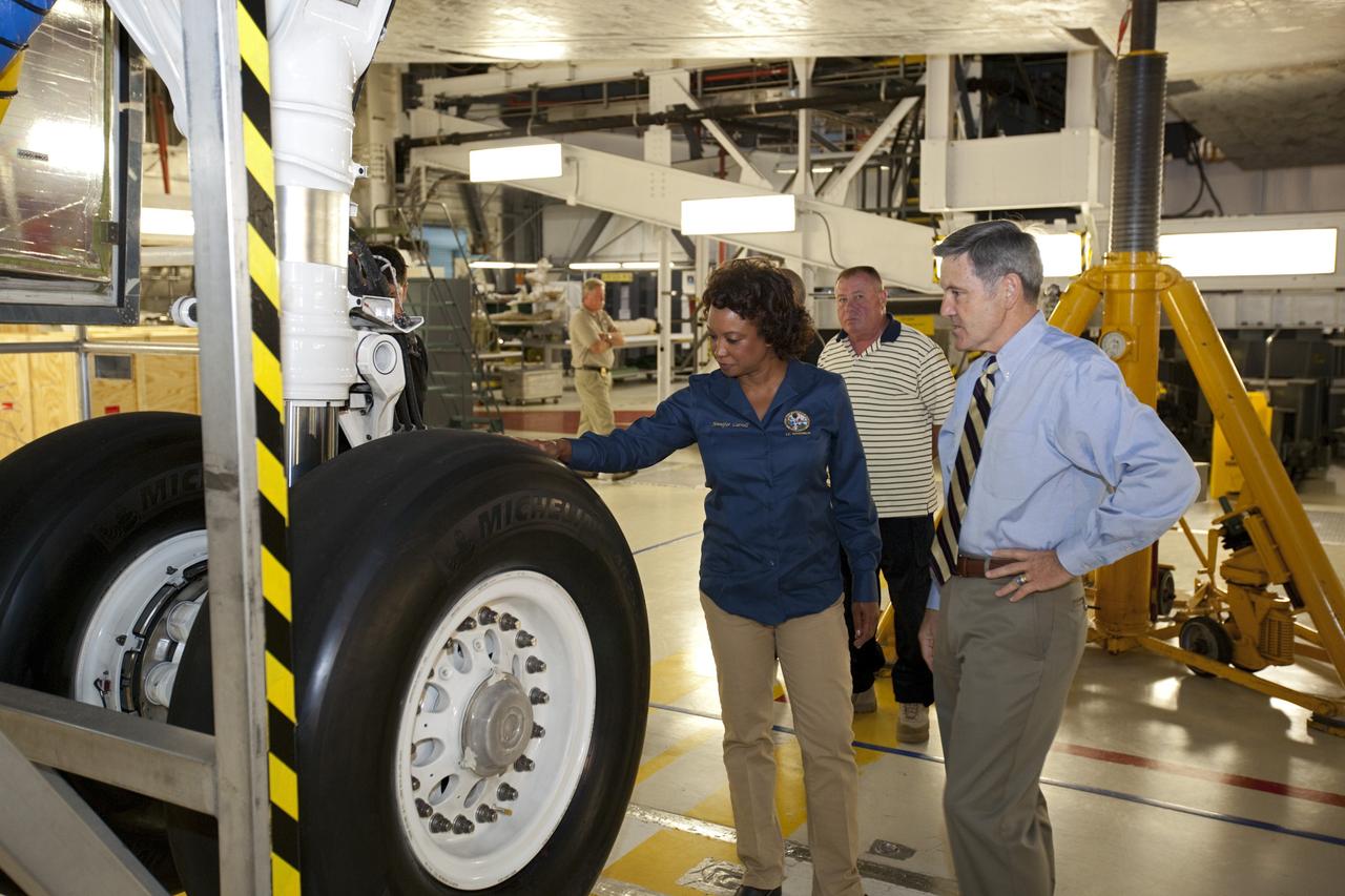 CAPE CANAVERAL, Fla. – Florida’s Lt. Gov. Jennifer Carroll, left, examines one of the tires on space shuttle Atlantis during a tour of Kennedy Space Center’s Orbiter Processing Facility-1. Kennedy’s Director Bob Cabana, at right, is her guide. The tour coincided with Carroll’s visit to Kennedy for a meeting with Cabana. Atlantis is being prepared for public display at the Kennedy Space Center Visitor Complex in 2013. The groundbreaking for Atlantis’ exhibit hall took place in January Atlantis is scheduled to be moved to the visitor complex in November. For more information, visit http://www.nasa.gov/shuttle. Photo credit: NASA/Jim Grossmann