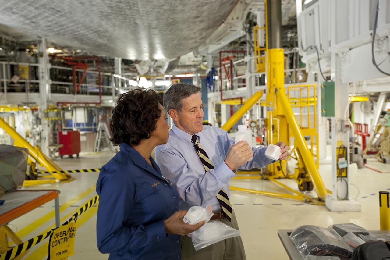 CAPE CANAVERAL, Fla. – Kennedy Space Center Director Bob Cabana, right, shows a space shuttle low-temperature reusable surface insulation LRSI tile to Florida’s Lt. Gov. Jennifer Carroll during a tour of Kennedy’s Orbiter Processing Facility-1. The tile is part of the shuttle’s thermal protection system which covers the shuttle’s exterior and protects it from the heat of re-entry. The tour coincided with Carroll’s visit to Kennedy for a meeting with Cabana. Atlantis is being prepared for public display at the Kennedy Space Center Visitor Complex in 2013. The groundbreaking for Atlantis’ exhibit hall took place in January Atlantis is scheduled to be moved to the visitor complex in November. For more information, visit http://www.nasa.gov/shuttle. Photo credit: NASA/Jim Grossmann