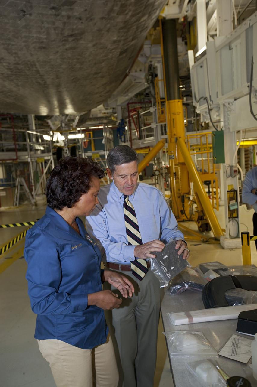 CAPE CANAVERAL, Fla. – Kennedy Space Center Director Bob Cabana, right, shows a space shuttle   high-temperature reusable surface insulation HRSI tile to Florida’s Lt. Gov. Jennifer Carroll during a tour of Kennedy’s Orbiter Processing Facility-1. The tile is part of the shuttle’s thermal protection system which covers the shuttle’s exterior and protects it from the heat of re-entry.      The tour coincided with Carroll’s visit to Kennedy for a meeting with Cabana. Atlantis is being prepared for public display at the Kennedy Space Center Visitor Complex in 2013. The groundbreaking for Atlantis’ exhibit hall took place in January Atlantis is scheduled to be moved to the visitor complex in November. For more information, visit http://www.nasa.gov/shuttle.  Photo credit: NASA/Jim Grossmann