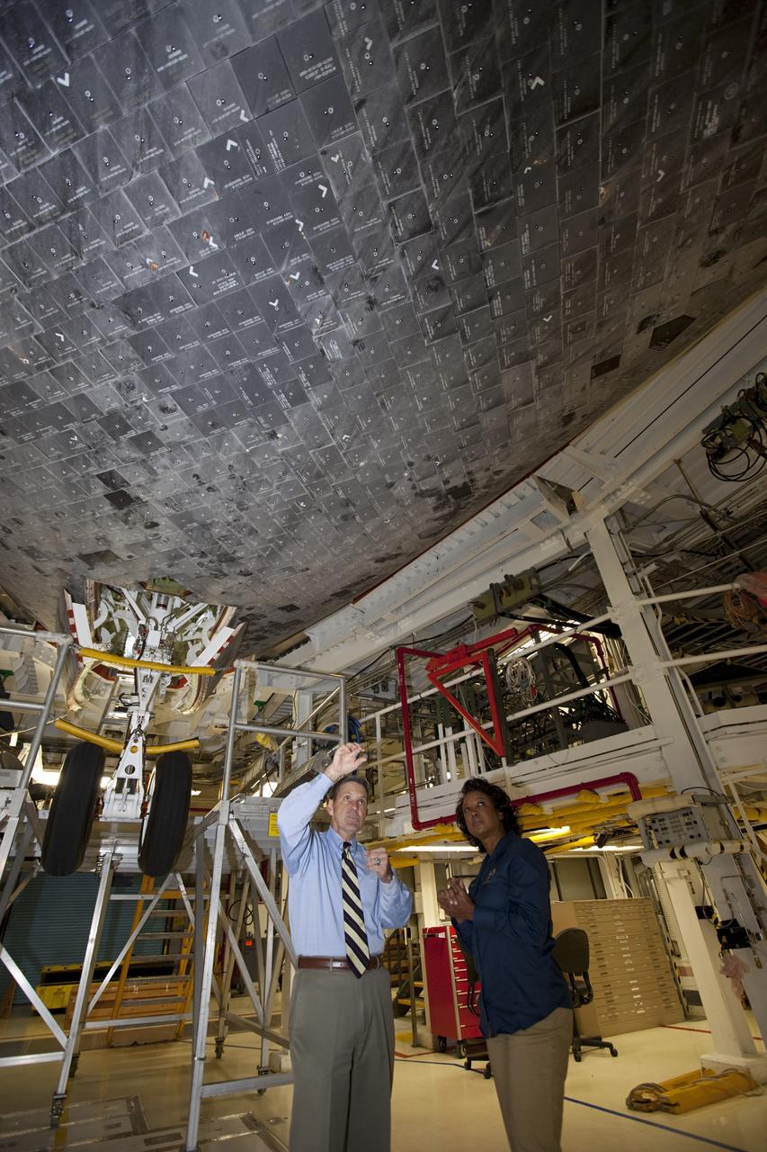CAPE CANAVERAL, Fla. – Kennedy Space Center Director Bob Cabana, left, explains the placement of high-temperature reusable surface insulation HRSI tile on the underbelly of space shuttle Atlantis to Florida’s Lt. Gov. Jennifer Carroll during a tour of Kennedy’s Orbiter Processing Facility-1. The tile is part of the shuttle’s thermal protection system which covers the shuttle’s exterior and protects it from the heat of re-entry. The tour coincided with Carroll’s visit to Kennedy for a meeting with Cabana. Atlantis is being prepared for public display at the Kennedy Space Center Visitor Complex in 2013. The groundbreaking for Atlantis’ exhibit hall took place in January Atlantis is scheduled to be moved to the visitor complex in November. For more information, visit http://www.nasa.gov/shuttle. Photo credit: NASA/Jim Grossmann