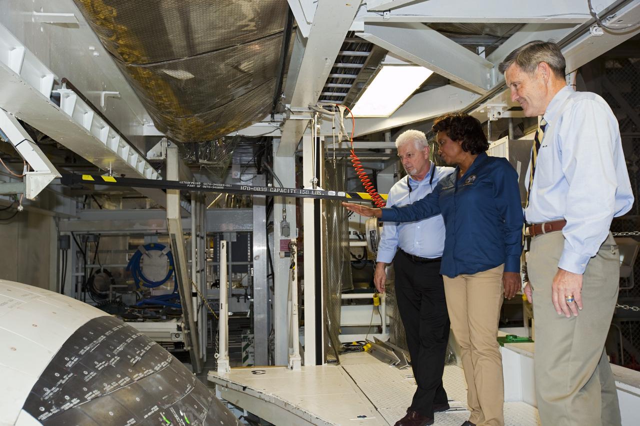 CAPE CANAVERAL, Fla. – Florida’s Lt. Gov. Jennifer Carroll asks questions of her guides during a tour of Kennedy Space Center’s Orbiter Processing Facility-1 as they scrutinize the forward end of space shuttle Atlantis. United Space Alliance manager Buddy McKenzie is at left, and Kennedy Director Bob Cabana, at right. The tour coincided with Carroll’s visit to Kennedy for a meeting with Cabana. Atlantis is being prepared for public display at the Kennedy Space Center Visitor Complex in 2013. The groundbreaking for Atlantis’ exhibit hall took place in January Atlantis is scheduled to be moved to the visitor complex in November. For more information, visit http://www.nasa.gov/shuttle. Photo credit: NASA/Jim Grossmann