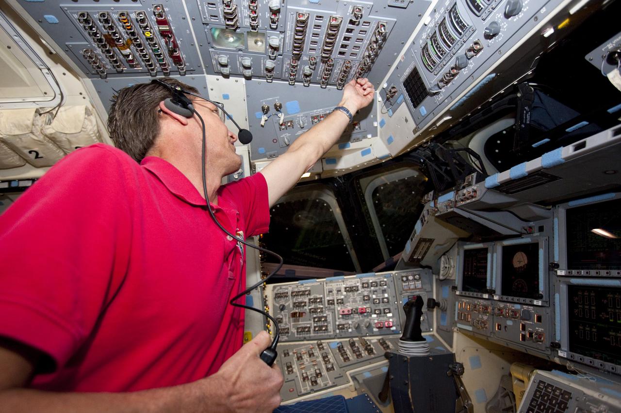 CAPE CANAVERAL, Fla. – In Orbiter Processing Facility-2 at NASA's Kennedy Space Center in Florida, United Space Alliance senior aerospace technician and spacecraft operator Charles J. Beason toggles the switches on space shuttle Endeavour’s flight deck during Space Shuttle Program transition and retirement activities. Endeavour is being prepared for public display at the California Science Center in Los Angeles. Over the course of its 19-year career, Endeavour spent 299 days in space during 25 missions. For more information, visit http://www.nasa.gov/shuttle. Photo credit: NASA/Dimitri Gerondidakis