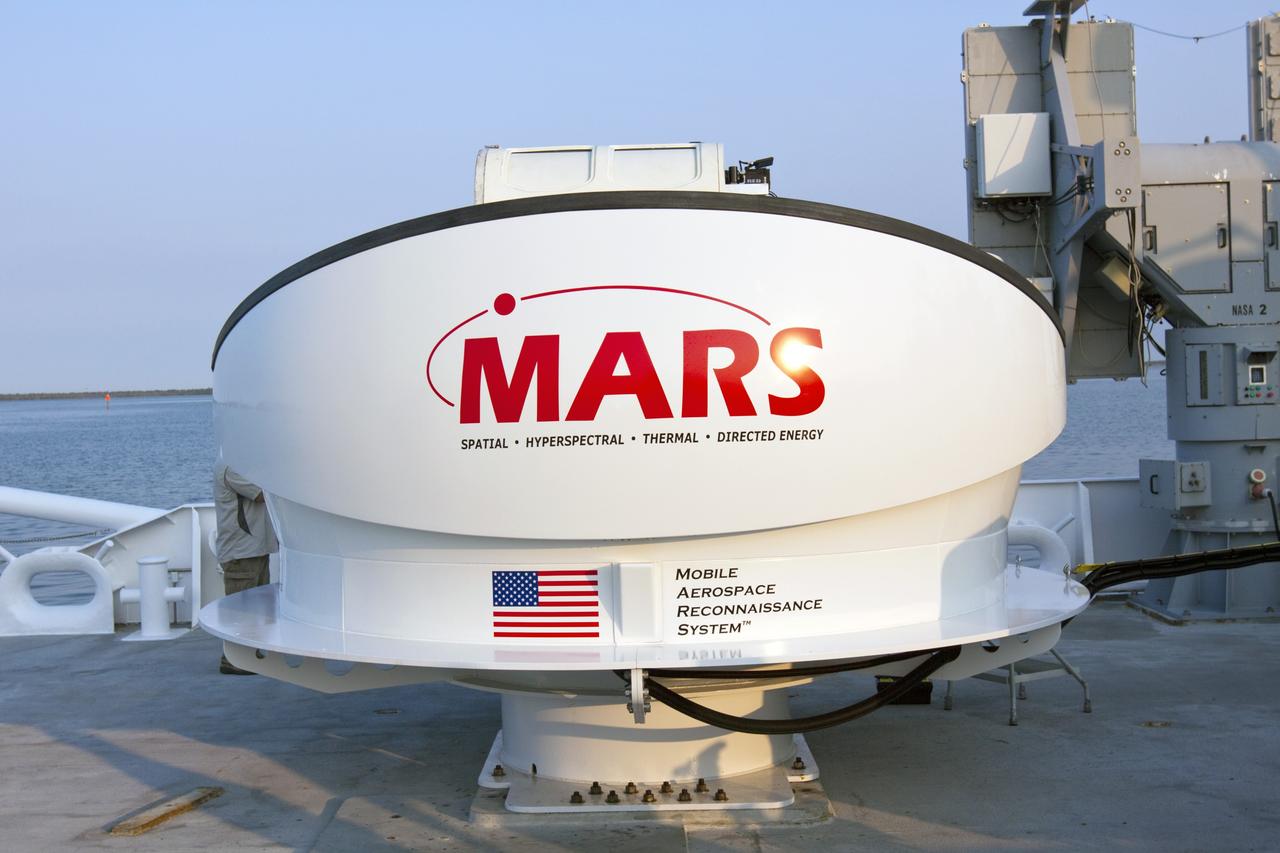 CAPE CANAVERAL, Fla. -- NASA’s Mobile Aerospace Reconnaissance System, or MARS, is secured aboard NASA’s Freedom Star boat near Hangar AE at Cape Canaveral Air Force Station in Florida. MARS is being prepared for a day of testing after departing from Port Canaveral out to the Atlantic Ocean.    MARS, run by NASA’s Langley Research Center in Hampton, Va., with its spatial, hyperspectral, thermal, and directed energy capabilities will be used for thermal imaging testing for the upcoming SpaceX Falcon 9 and Dragon capsule test flight to the International Space Station. During today’s test, the MARS X-band radar and kineto tracking mount KTM were tested to ensure that they were synchronized to receive a rocket launch feed. The radar was used to identify an object to see if the KTM could lock on to and track it. The MARS team performed maintenance on the system, confirmed communications links, and tested the design of the mounting system and environmental enclosure. Photo credit: NASA/Jim Grossmann