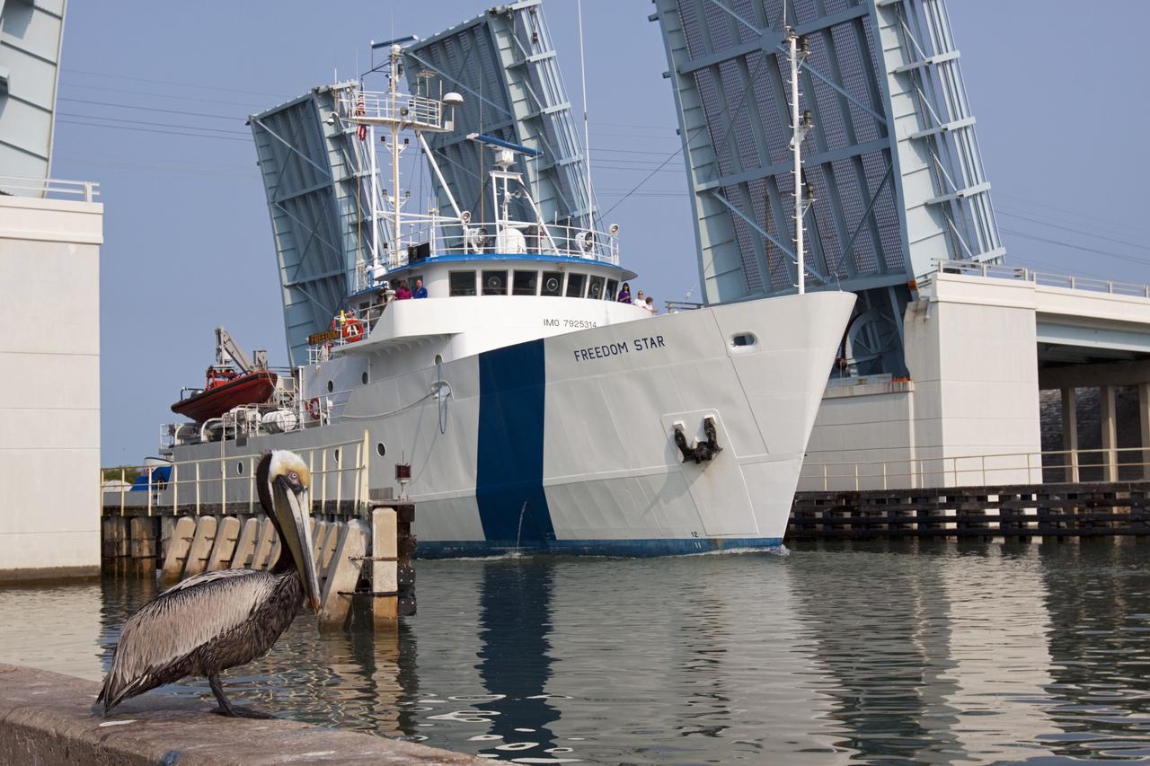 CAPE CANAVERAL, Fla. -- NASA’s Freedom Star boat sets out for a day of testing after departing from port near Cape Canaveral Air Force Station in Florida for the Atlantic Ocean with NASA’s Mobile Aerospace Reconnaissance System, or MARS, secured aboard.    MARS, run by NASA’s Langley Research Center in Hampton, Va., with its spatial, hyperspectral, thermal, and directed energy capabilities will be used for thermal imaging testing for the upcoming SpaceX Falcon 9 and Dragon capsule test flight to the International Space Station. During today’s test, the MARS X-band radar and kineto tracking mount KTM were tested to ensure that they were synchronized to receive a rocket launch feed. The radar was used to identify an object to see if the KTM could lock on to and track it. The MARS team performed maintenance on the system, confirmed communications links, and tested the design of the mounting system and environmental enclosure. Photo credit: NASA/Jim Grossmann