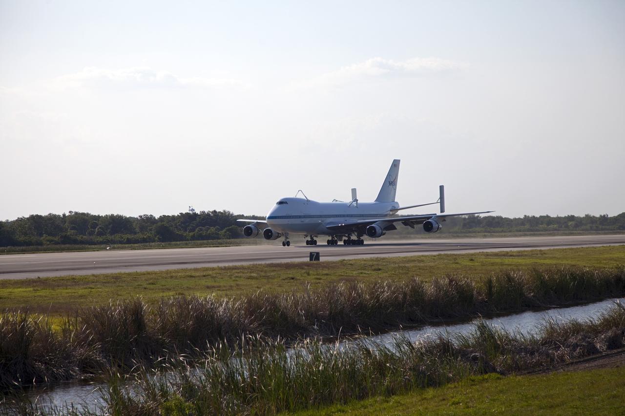 CAPE CANAVERAL, Fla. – The Shuttle Carrier Aircraft glides down the runway of the Shuttle Landing Facility at NASA’s Kennedy Space Center in Florida.    The aircraft, known as an SCA, arrived at 5:35 p.m. EDT to prepare for shuttle Discovery’s ferry flight to the Washington Dulles International Airport in Sterling, Va., on April 17. This SCA, designated NASA 905, is a modified Boeing 747 jet airliner, originally manufactured for commercial use. One of two SCAs employed over the course of the Space Shuttle Program, NASA 905 is assigned to the remaining ferry missions, delivering the shuttles to their permanent public display sites.  NASA 911 was decommissioned at the NASA Dryden Flight Research Center in California in February. Discovery will be placed on permanent public display in the Smithsonian's National Air and Space Museum Steven F. Udvar-Hazy Center in Chantilly, Va.  For more information on the SCA, visit http://www.nasa.gov/centers/dryden/news/FactSheets/FS-013-DFRC.html. For more information on shuttle transition and retirement activities, visit http://www.nasa.gov/shuttle. Photo credit: NASA/Frankie Martin